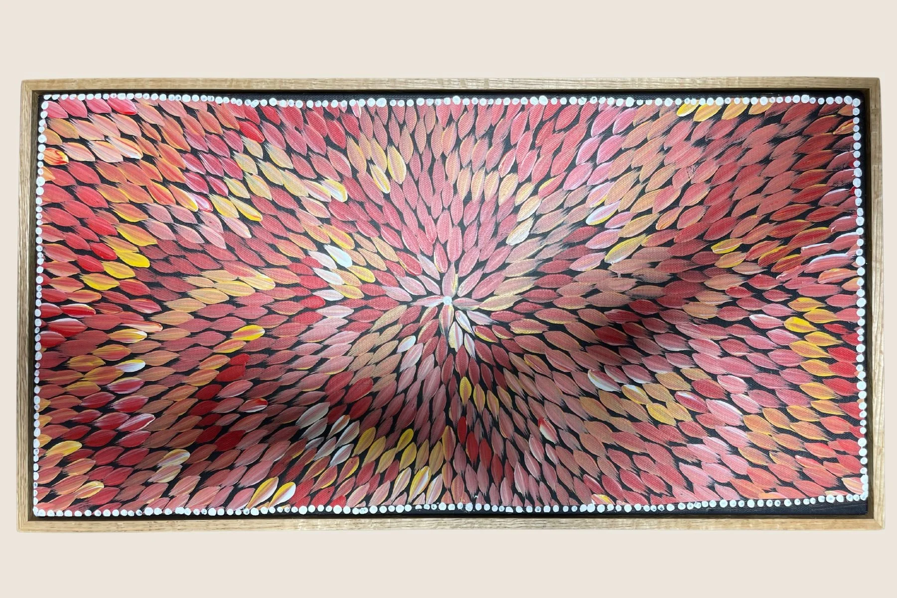 Aboriginal leaf motif painting in a natural oak float frame