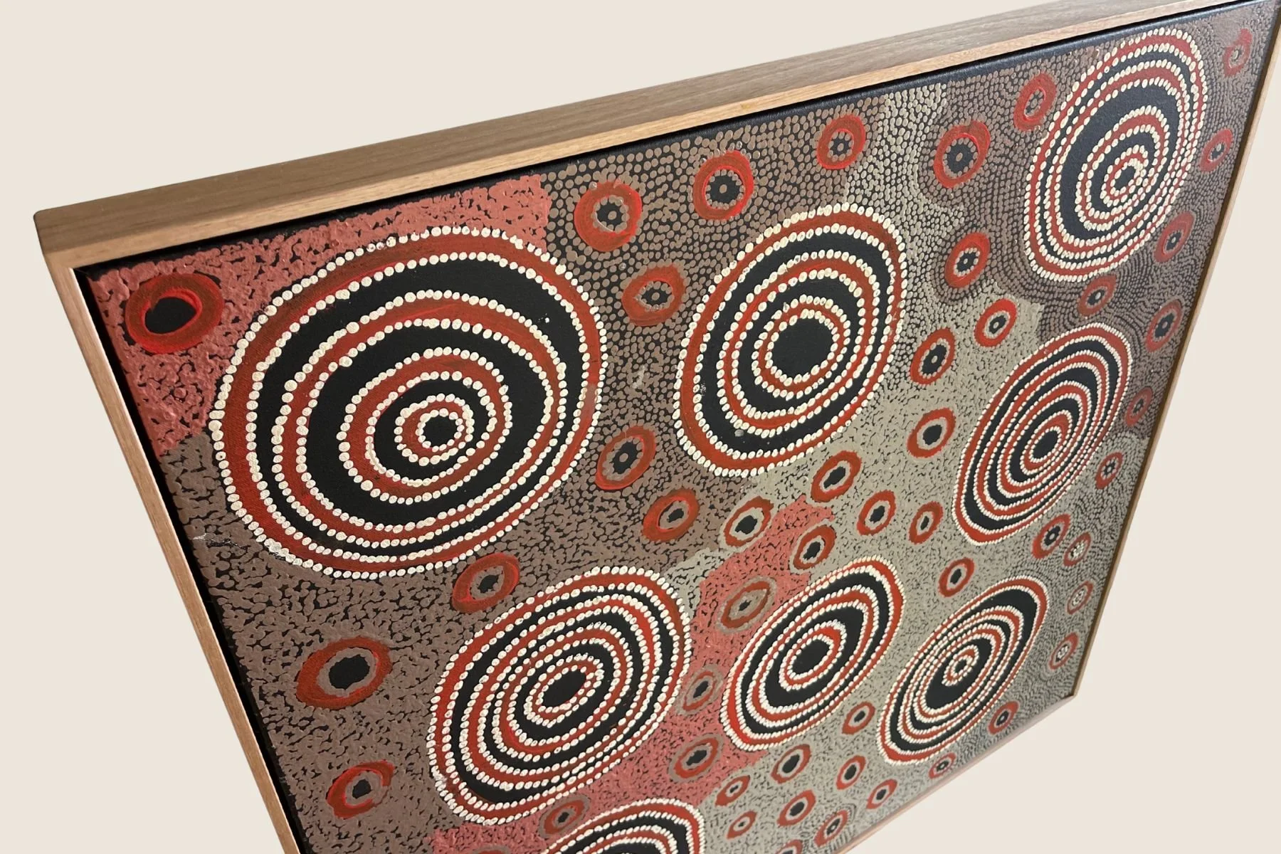 Aboriginal concentric circle painting in a natural oak float frame
