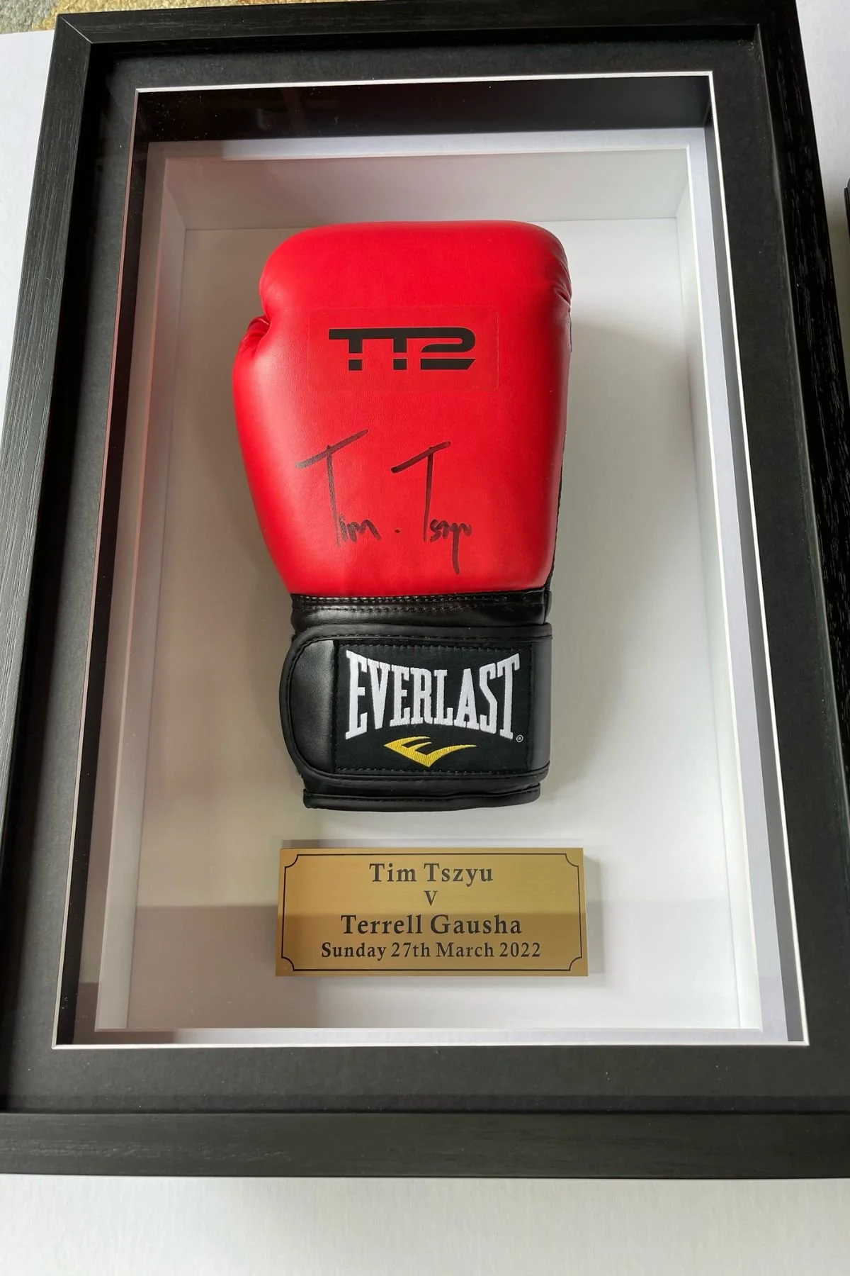 Signed Tim Tszyu boxing glove in a black shadow box frame