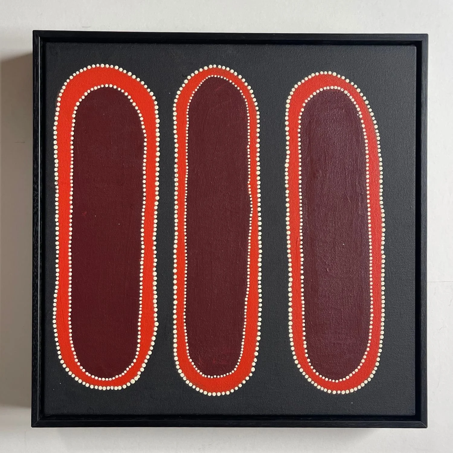 Aboriginal three-form painting in a slim black float frame