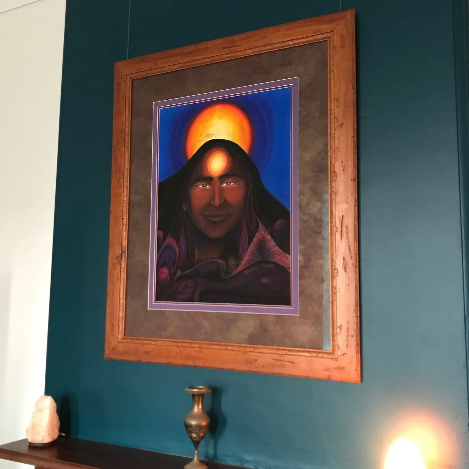Spirit guide portrait in a burled timber frame, installed over fireplace