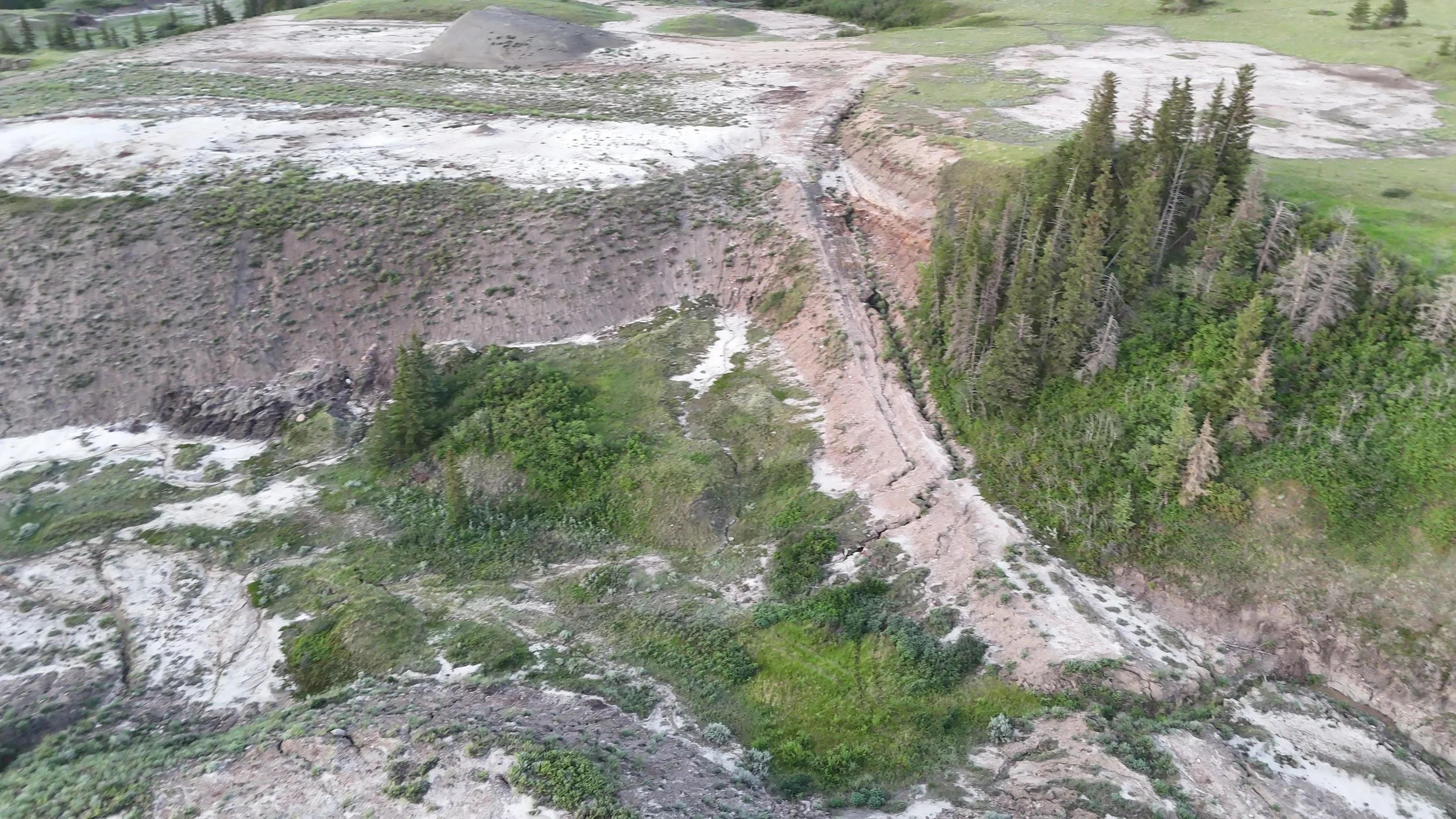 Deep piping and erosion channels as a result of sodium bentonite clay mining.  The Dressler mining site shut down 50 years ago and still shows scars today.  Long-term environmental damage and loss of vegetation and agricultural productivity.