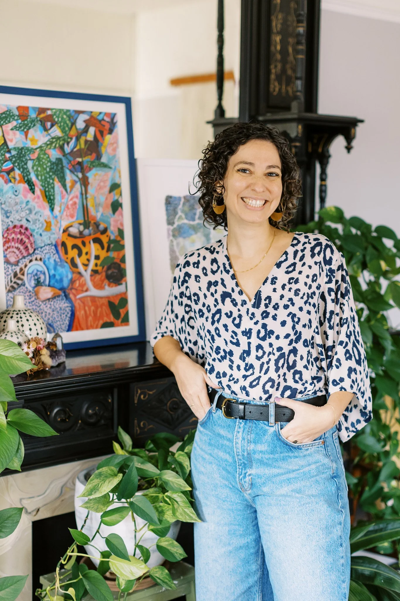 Jen Vera standing in front of art and plants