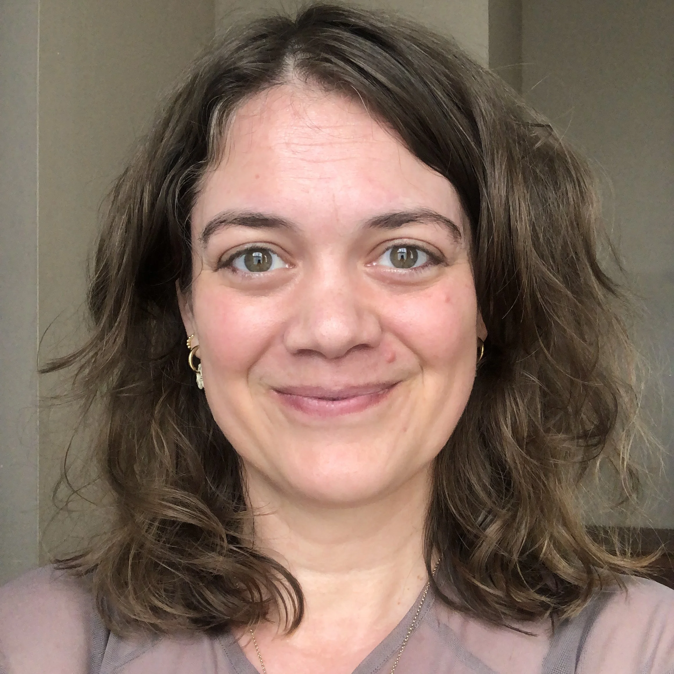 Photo of Katherine Saviskas. Light skin tone, hazel eyes, should length light brown hair