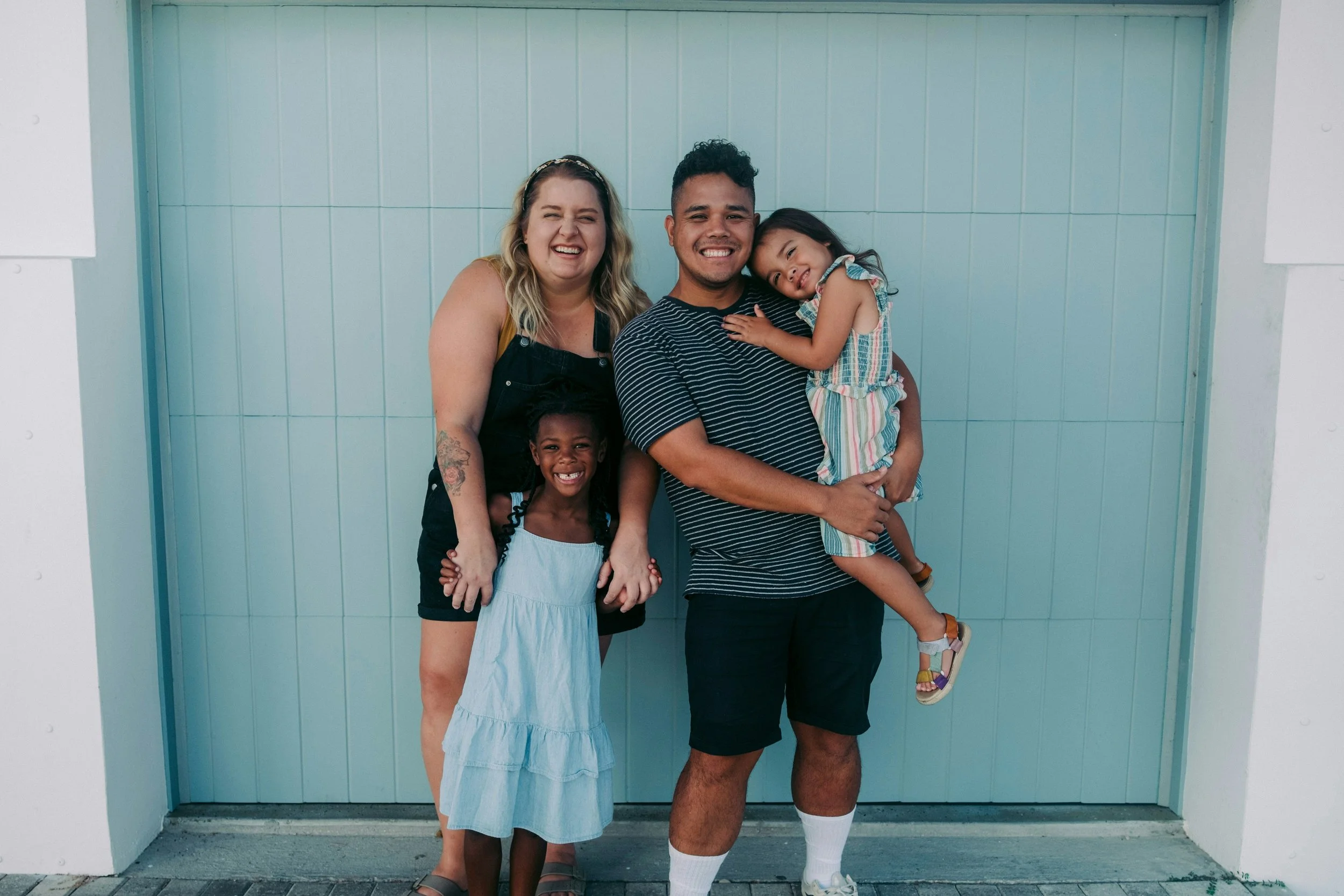 Mixed race group of two adults and two children appearing to be a family