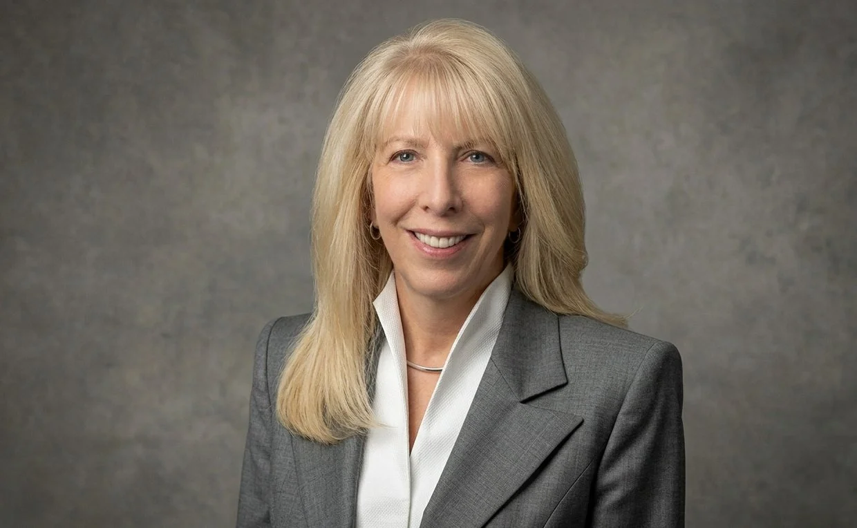 Mary McGovern Gebhardt of Collaboration & Innovation Management Consulting headshot, wearing a grey suit jacket and white collared shirt.