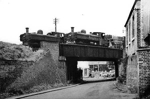 A black-and-white photo of a steam train passing through what would become the Brentford Beeline site.