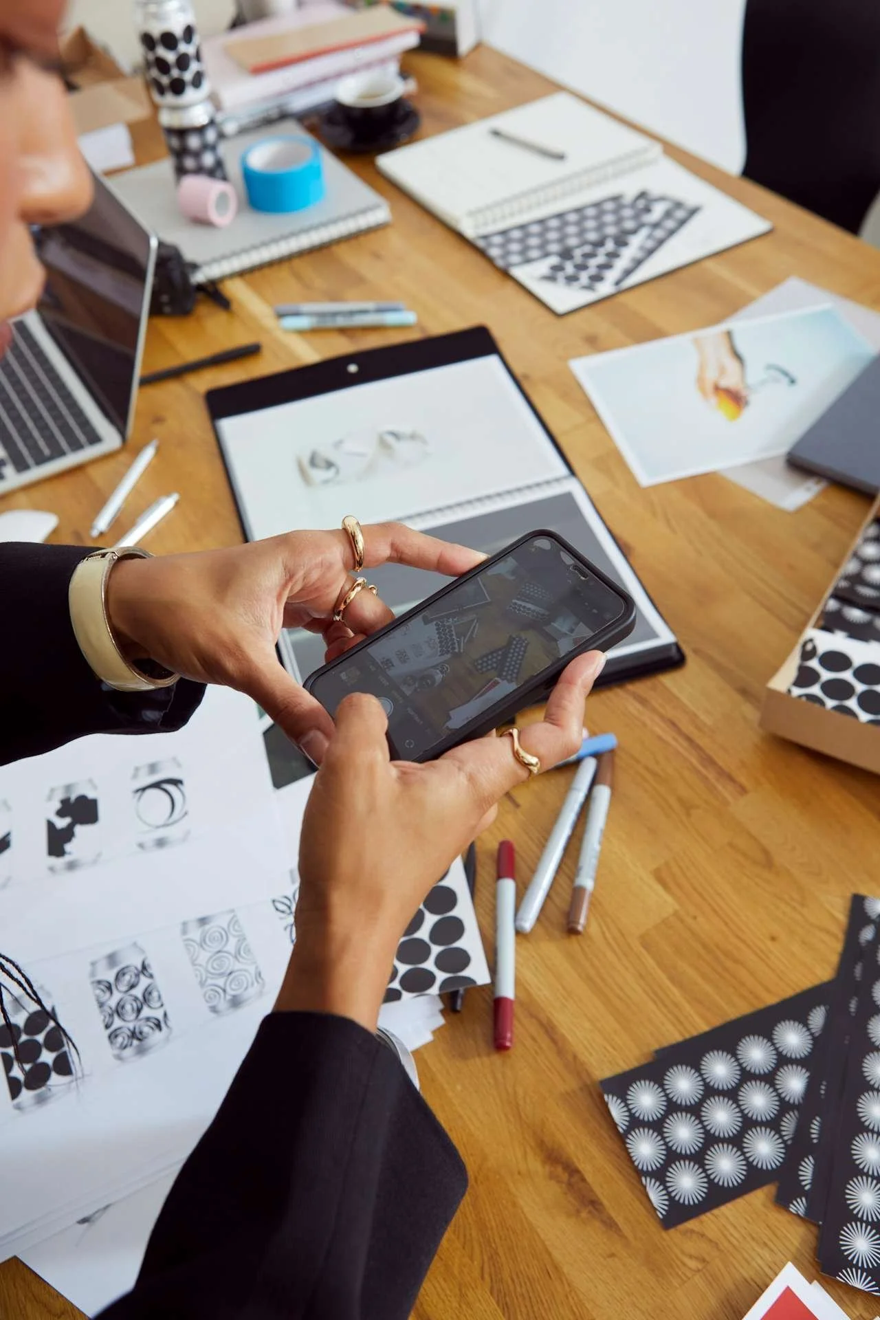 Brand designer working on authentic brand values strategy with packaging and design materials on desk