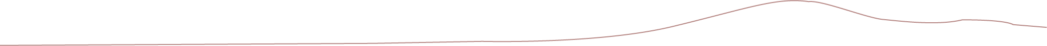 Multiple pink and white strings or threads laid out on a black surface.