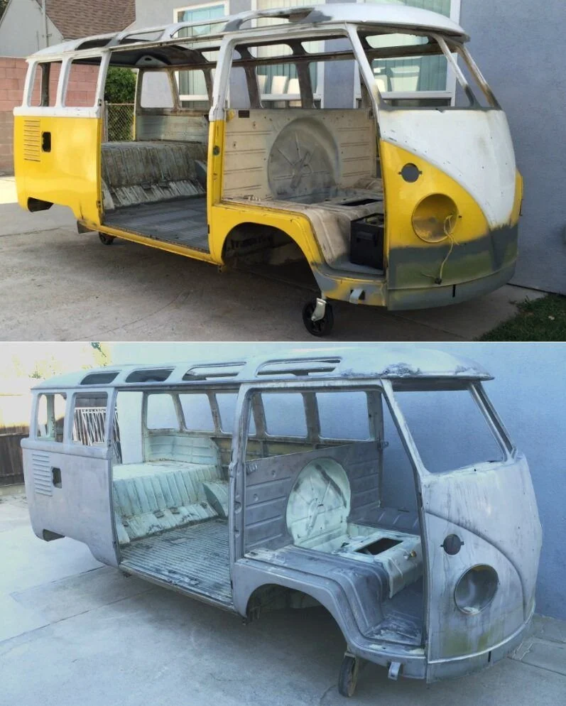 Two vintage Volkswagen Type 2 van shells, one painted yellow and white and the other unpainted, both stripped of interior components, showing metal frames.