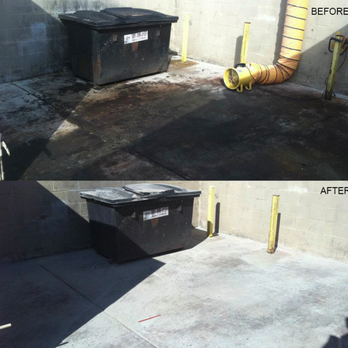 Comparison of a dirty, stained asphalt surface before cleaning and a clean, light concrete surface after cleaning outside a building with yellow piping and security measures.