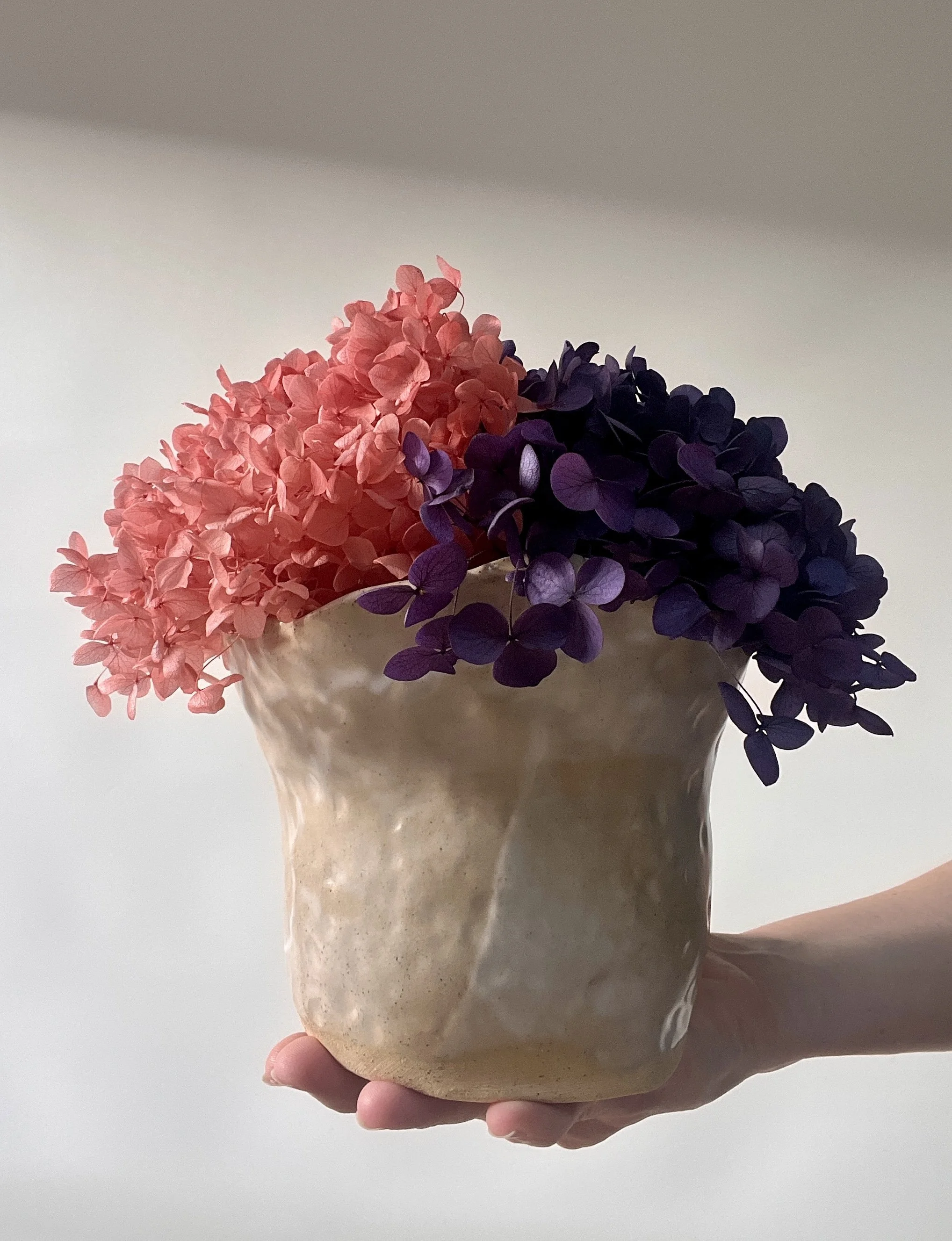 Wavy edge textured vessel with preserved floral arrangement