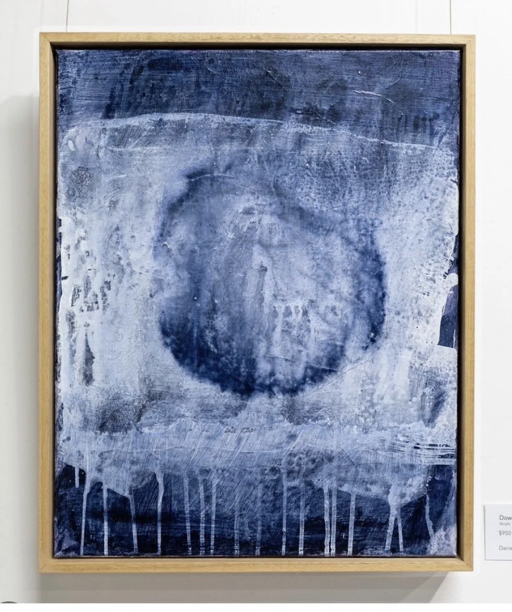 Abstract painting with blue and white tones, featuring a large circular shape in the center and dripping paint at the bottom.