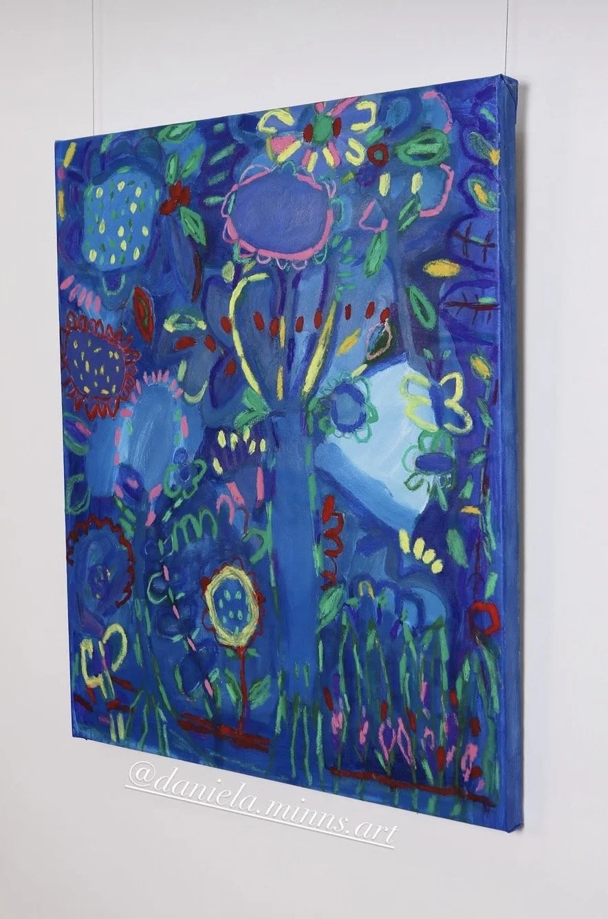 Bright, colorful abstract painting with flowers, plants, and foliage in shades of blue, green, pink, and red, on a white wall.