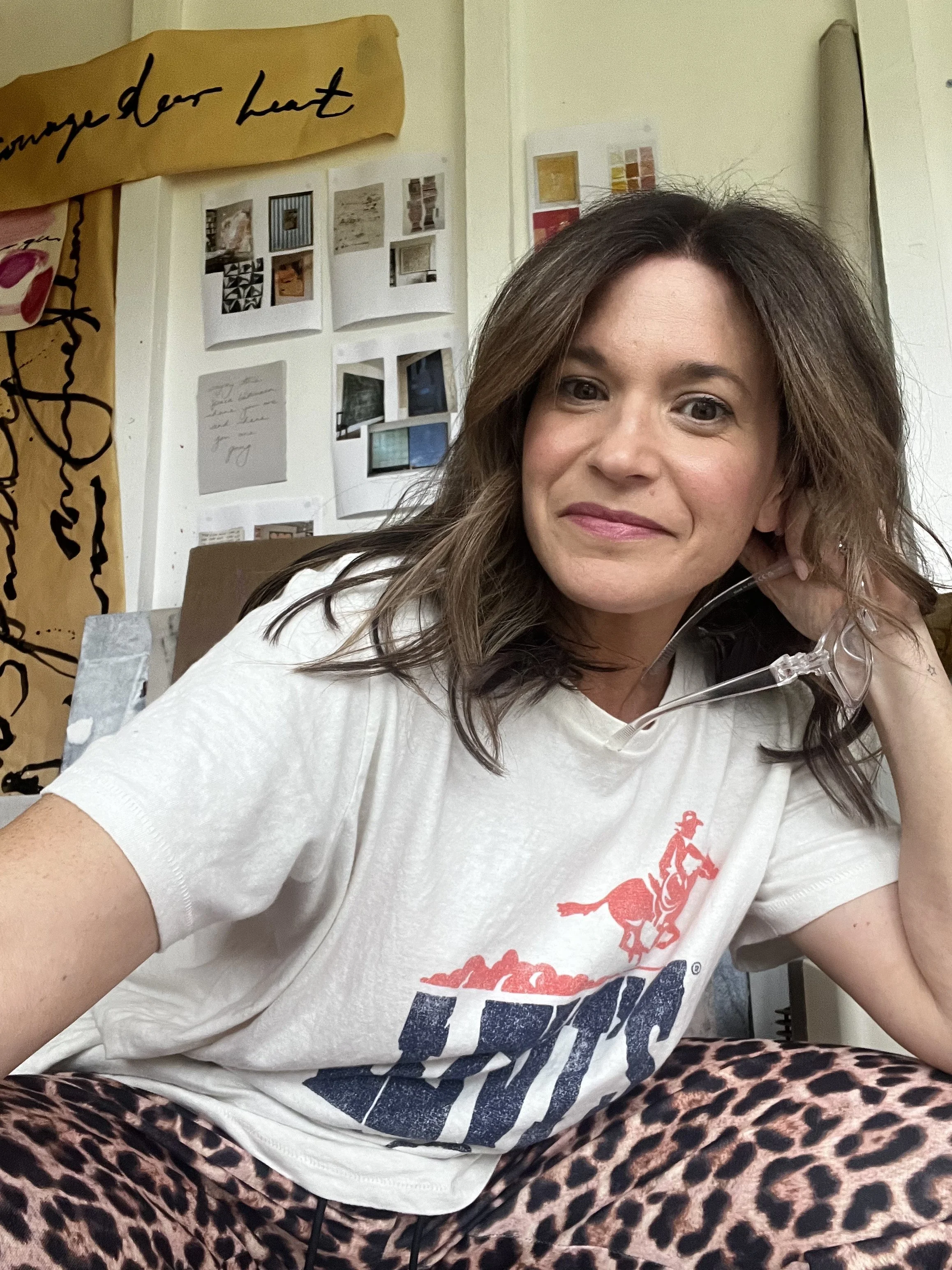 The artist is inside her Sydney based studio. Surrounded by her works and points of inspiration, her paints, brushes and other tools for creating. She is happy here and wants her work to communicate joy to the viewer and recipient.