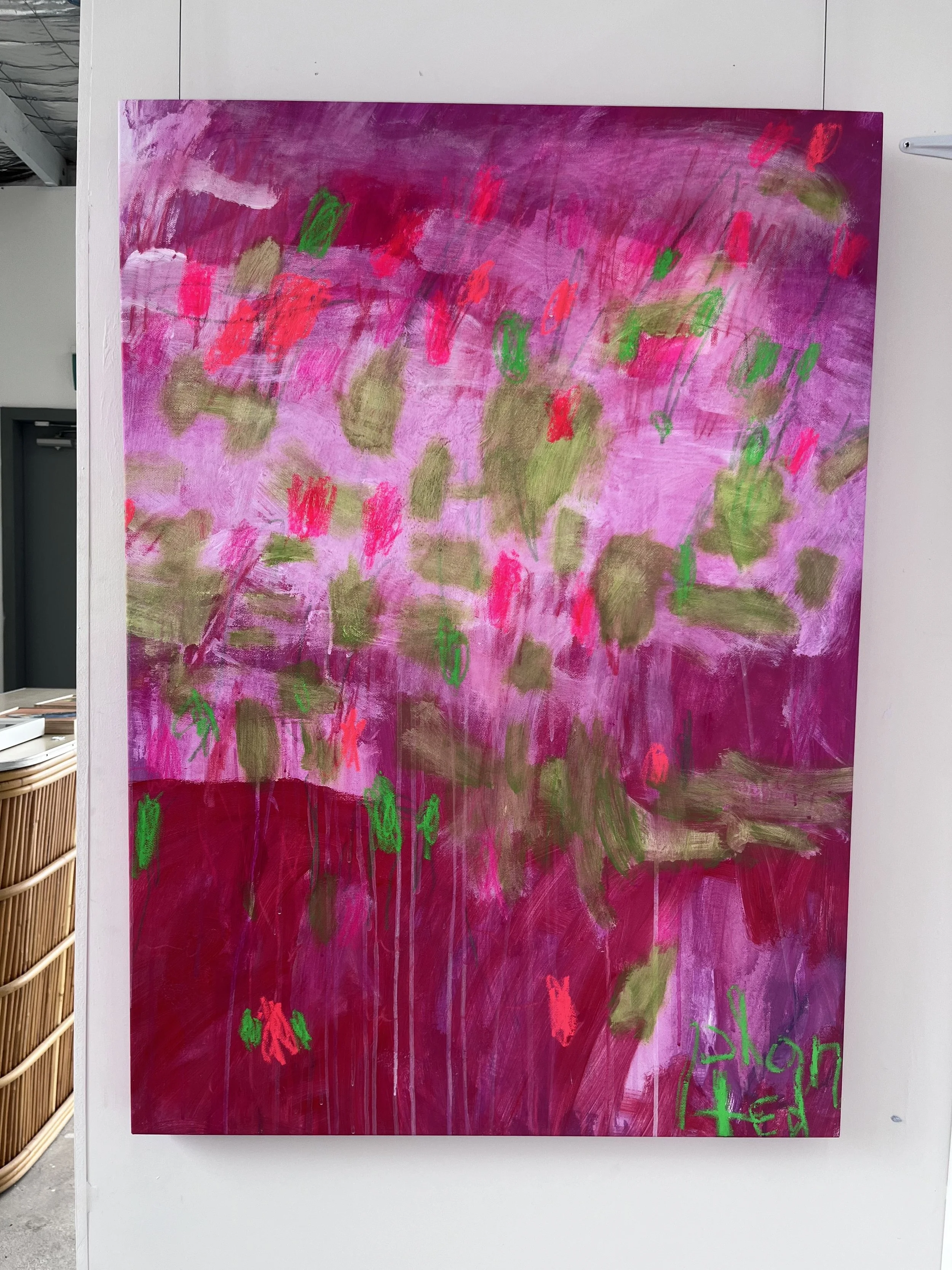 Abstract painting with pink, purple, and gold background, and green and red markings.