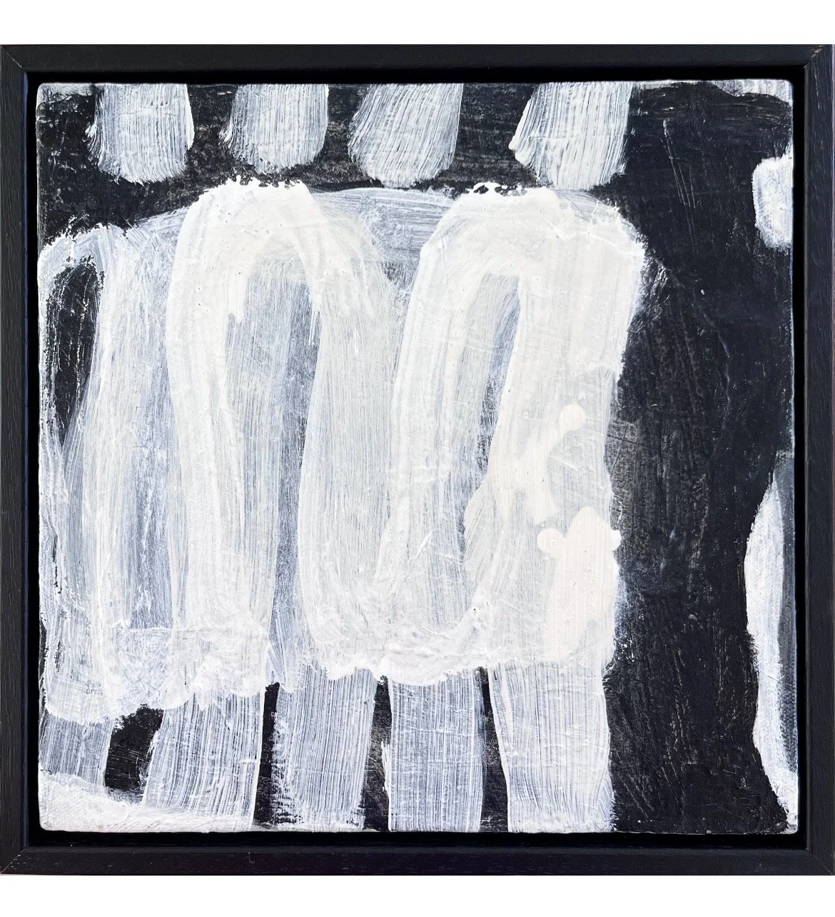 Abstract black and white painting with thick white strokes on a black background, framed in black.