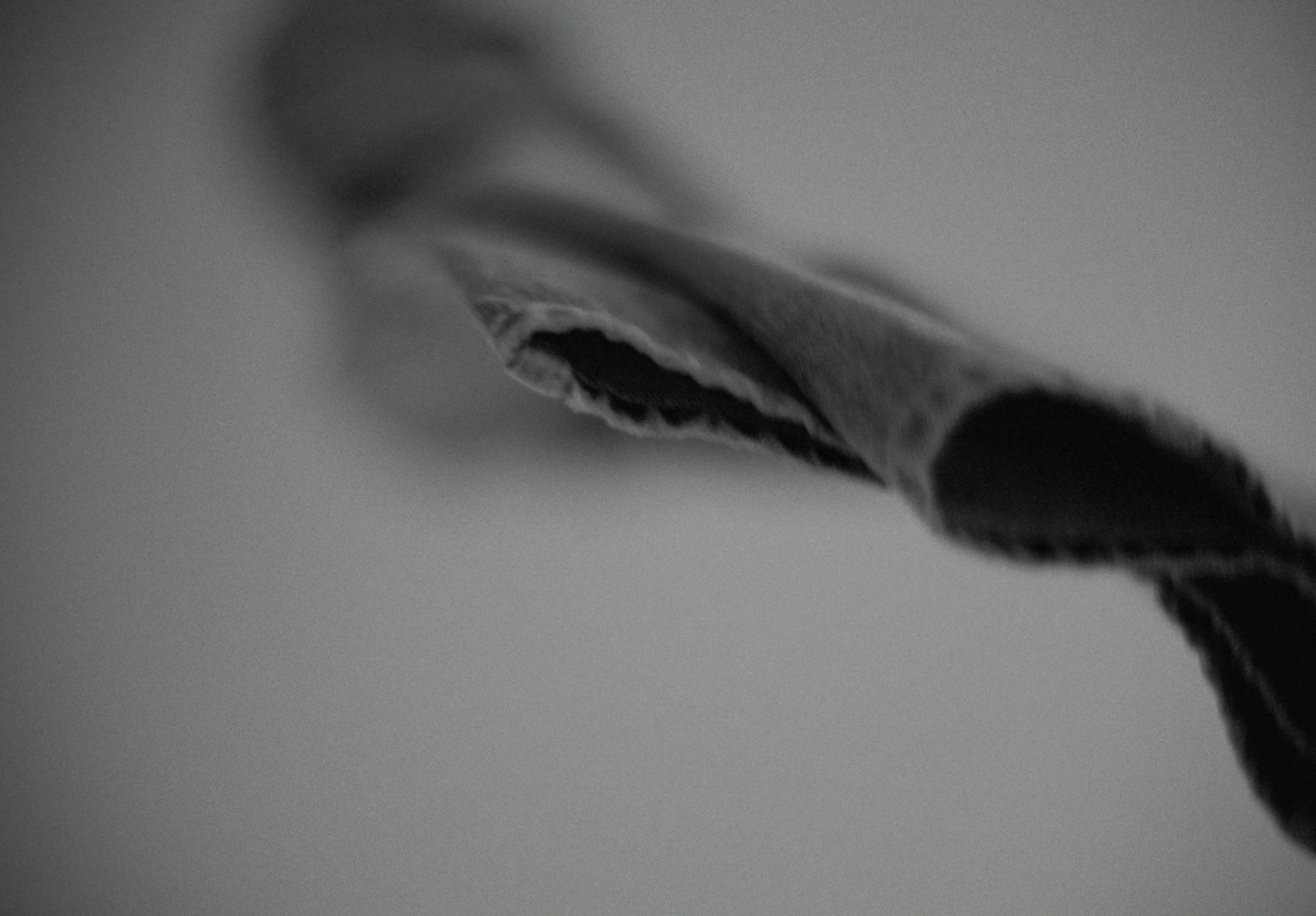 Close-up of a black ink pen tip on white paper.