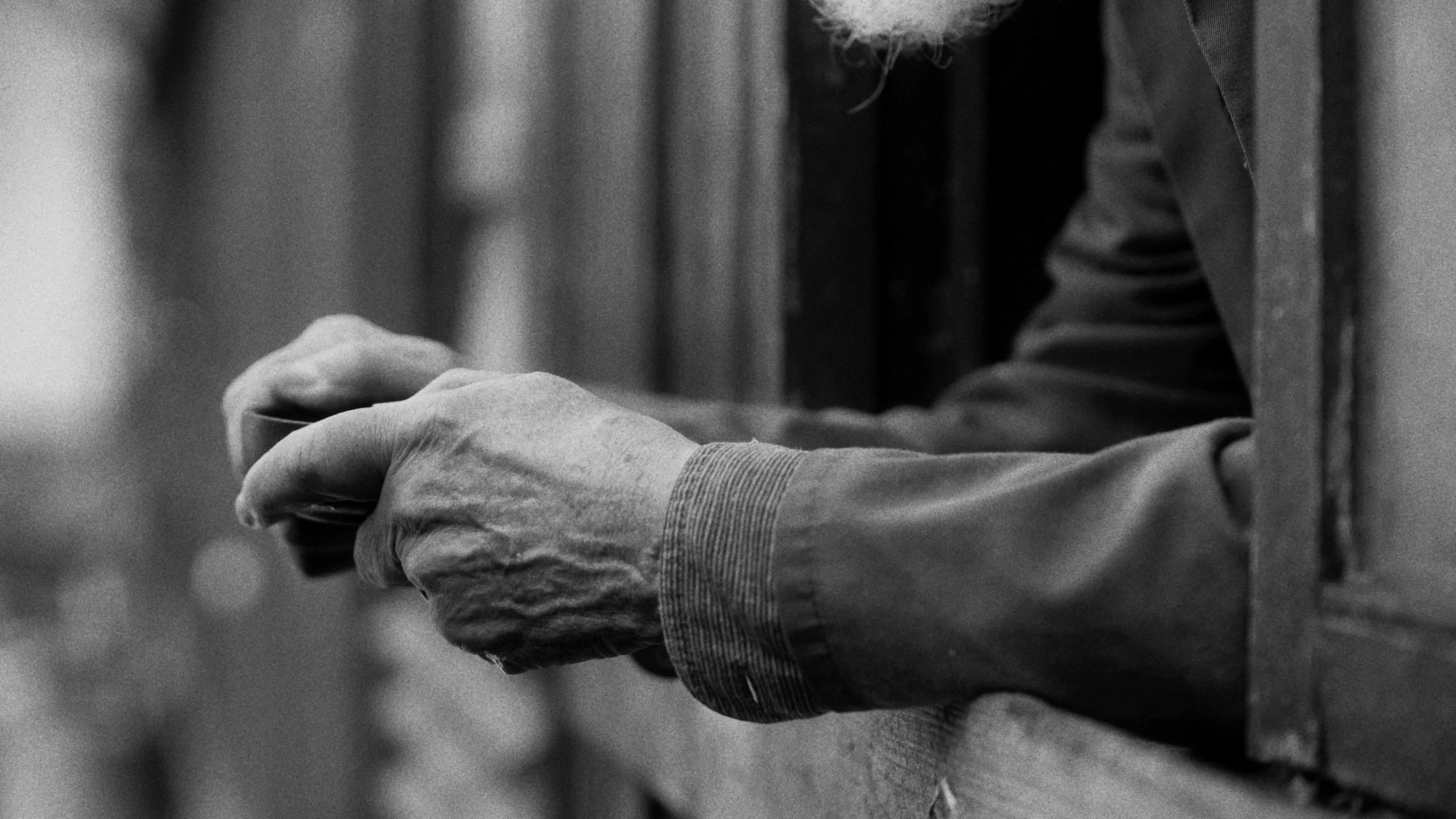 Close-up of a person's hands holding a smartphone, with a blurred background.