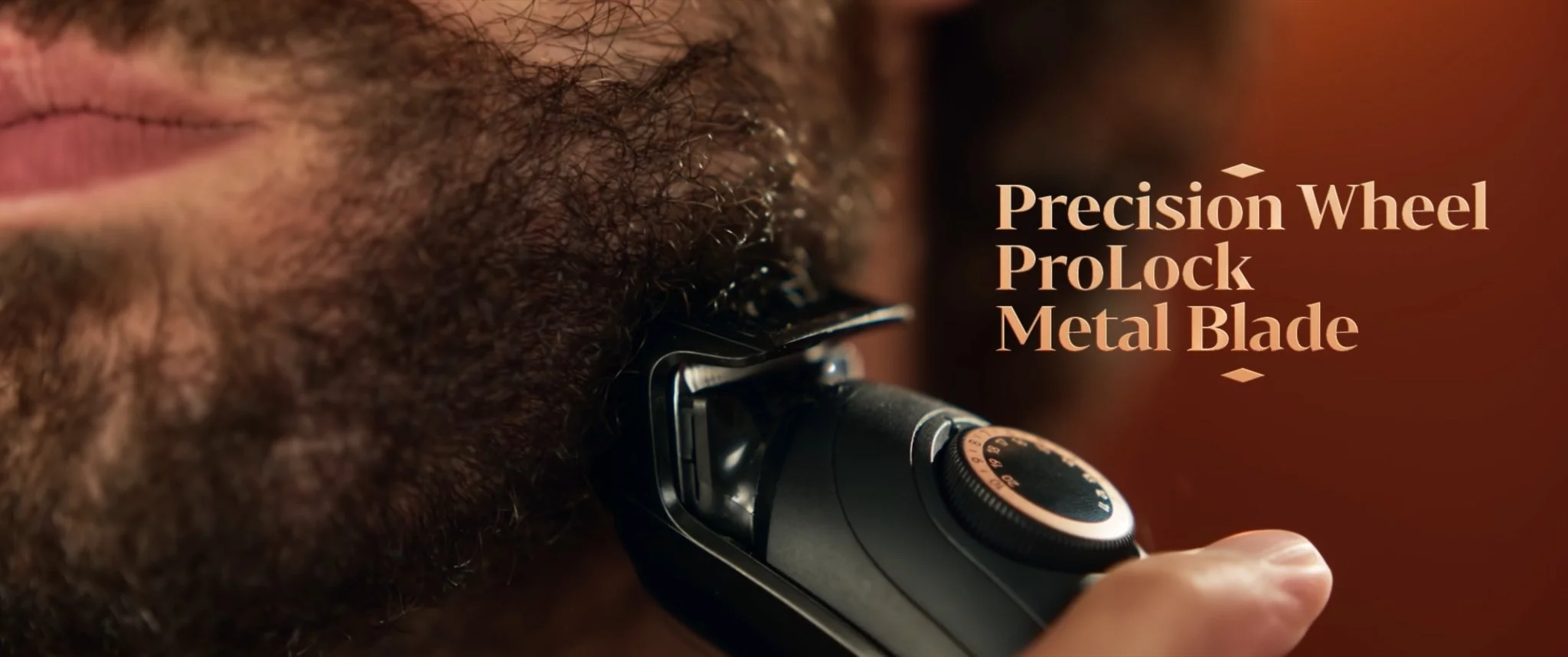 Close-up of a man with a beard using an electric shaver with a precision wheel and metal blade.