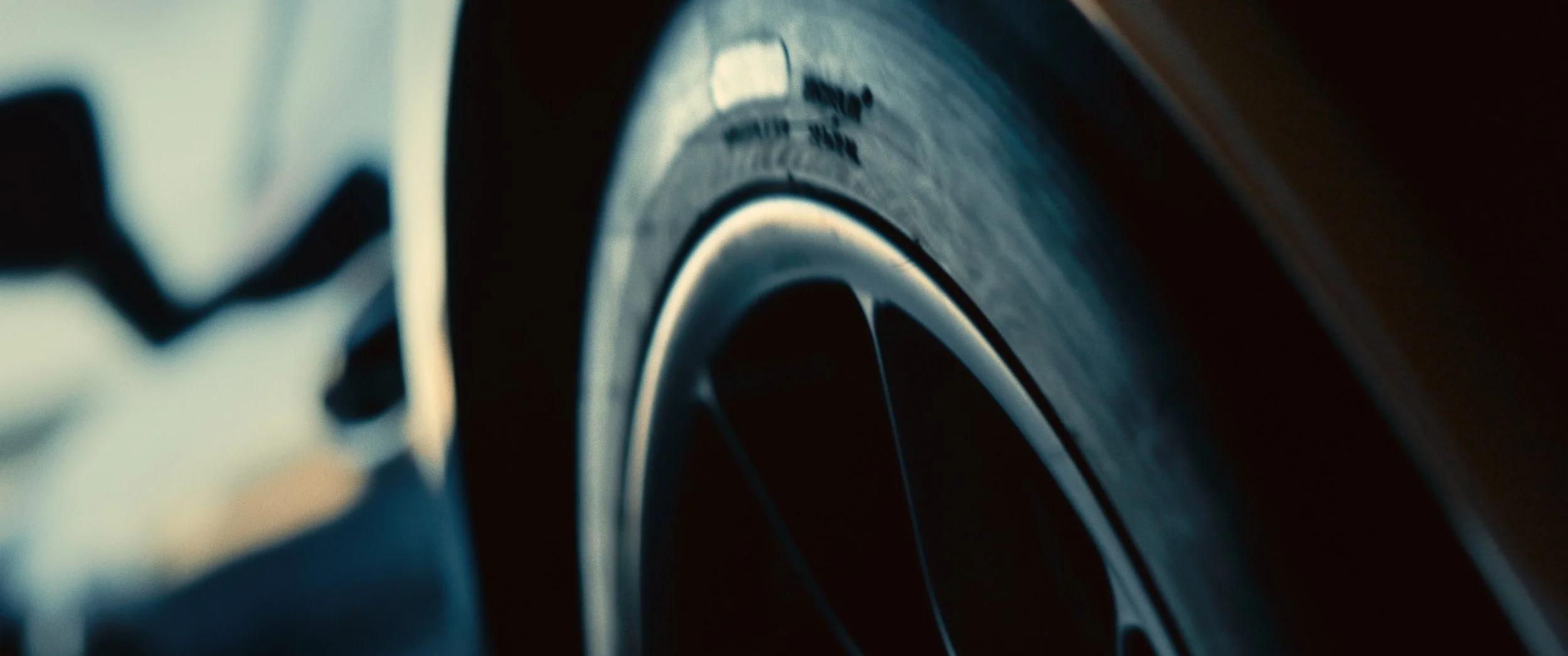 Close-up of a car wheel with a focus on the rim and tire.