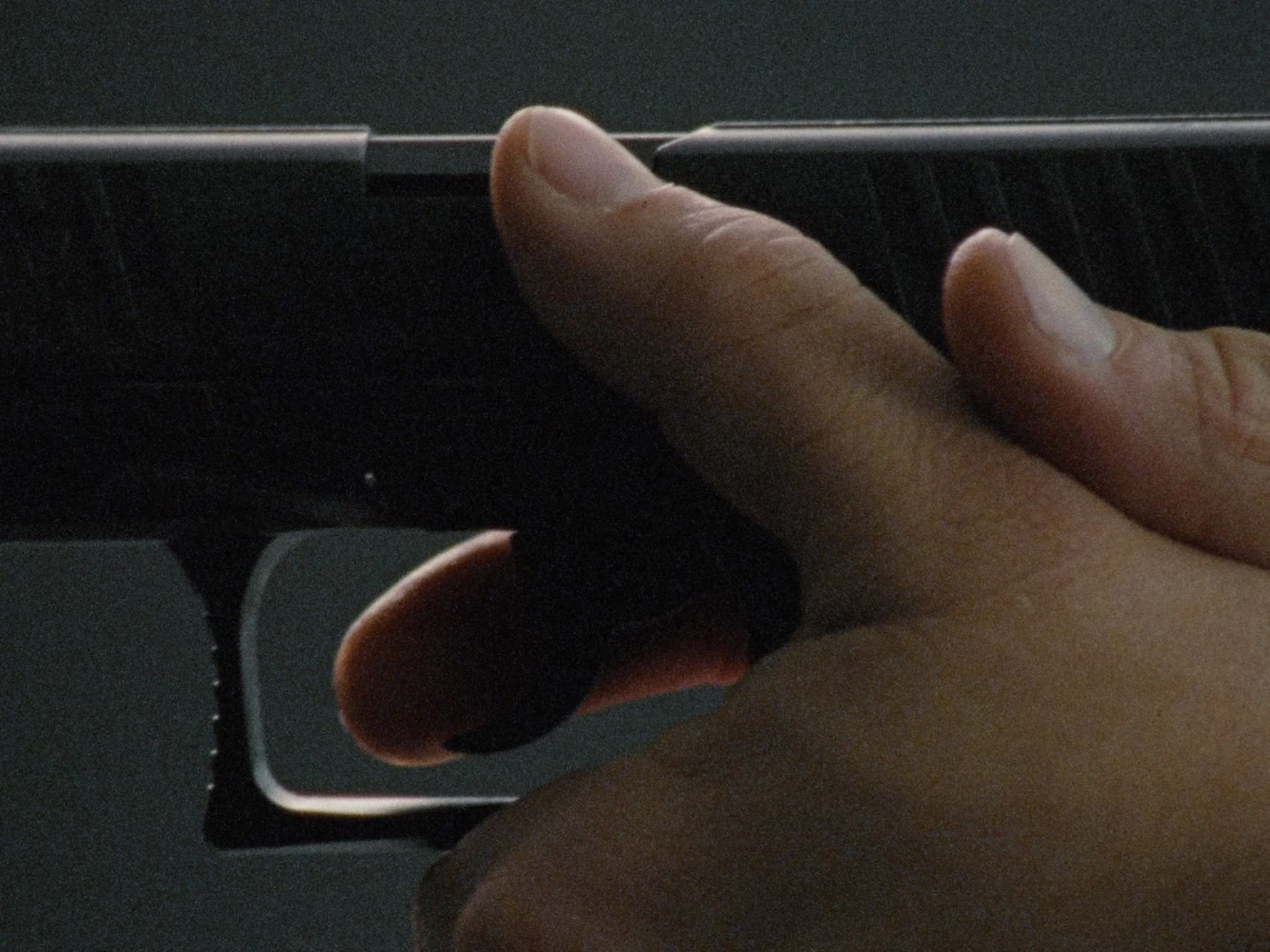 Close-up of a person's hand holding a smartphone, with a finger touching the screen.