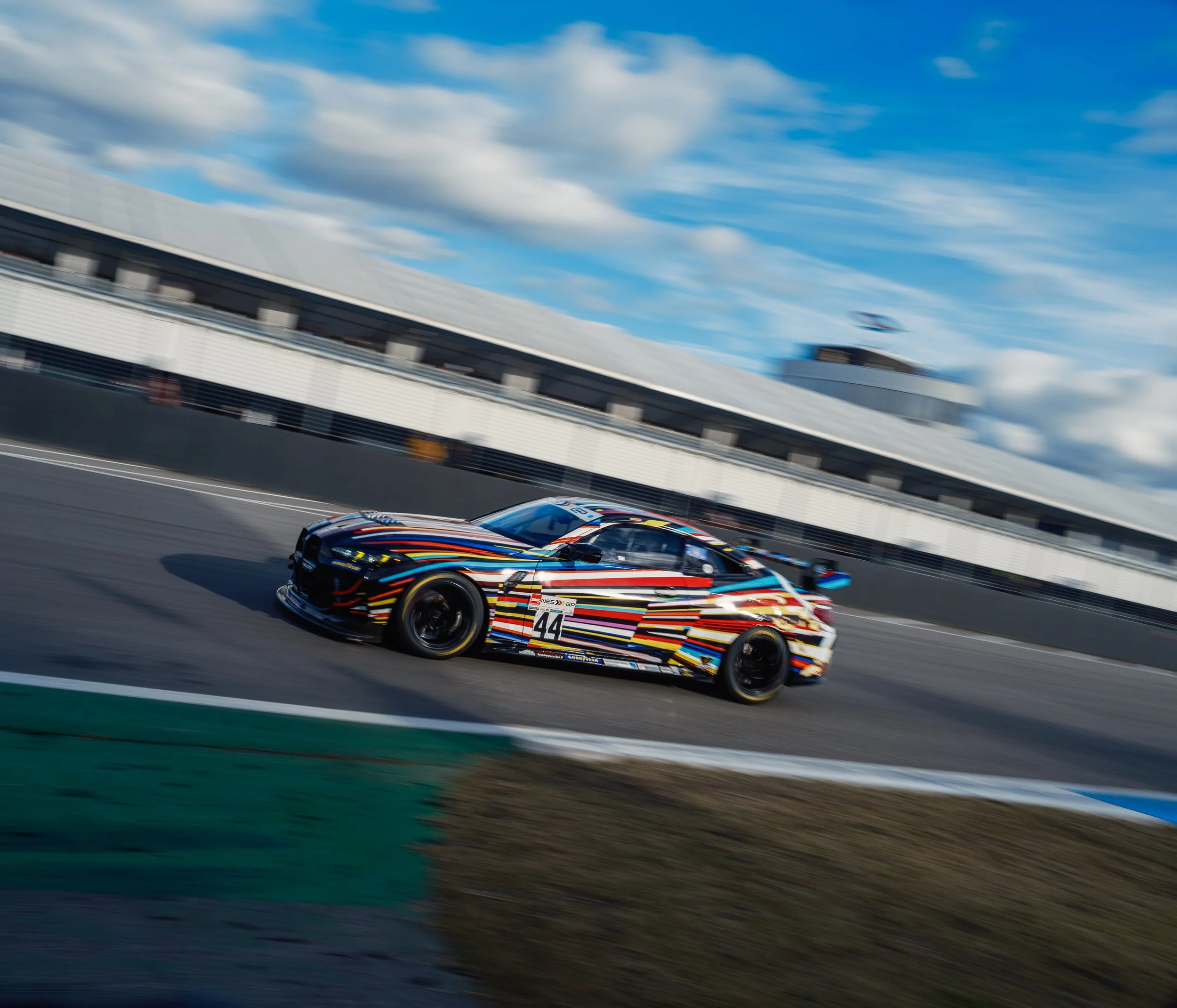 Colorful racing car on a race track during a race.