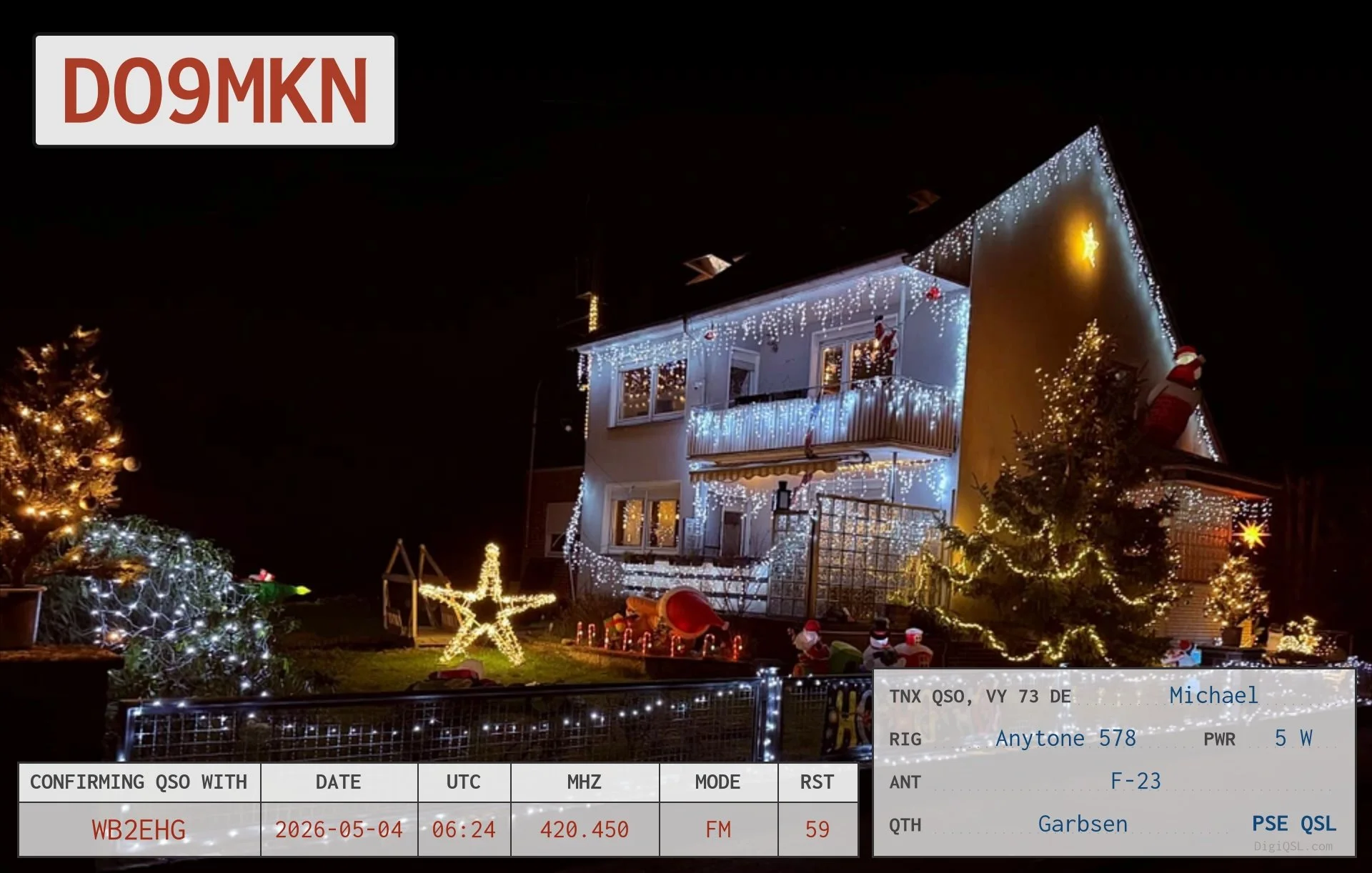 QSL card from Michael, DO9MKN, in Garbsen, Germany, confirming an FM contact with WB2EHG on May 4, 2026. The card features a house and garden covered in festive Christmas lights and decorations.