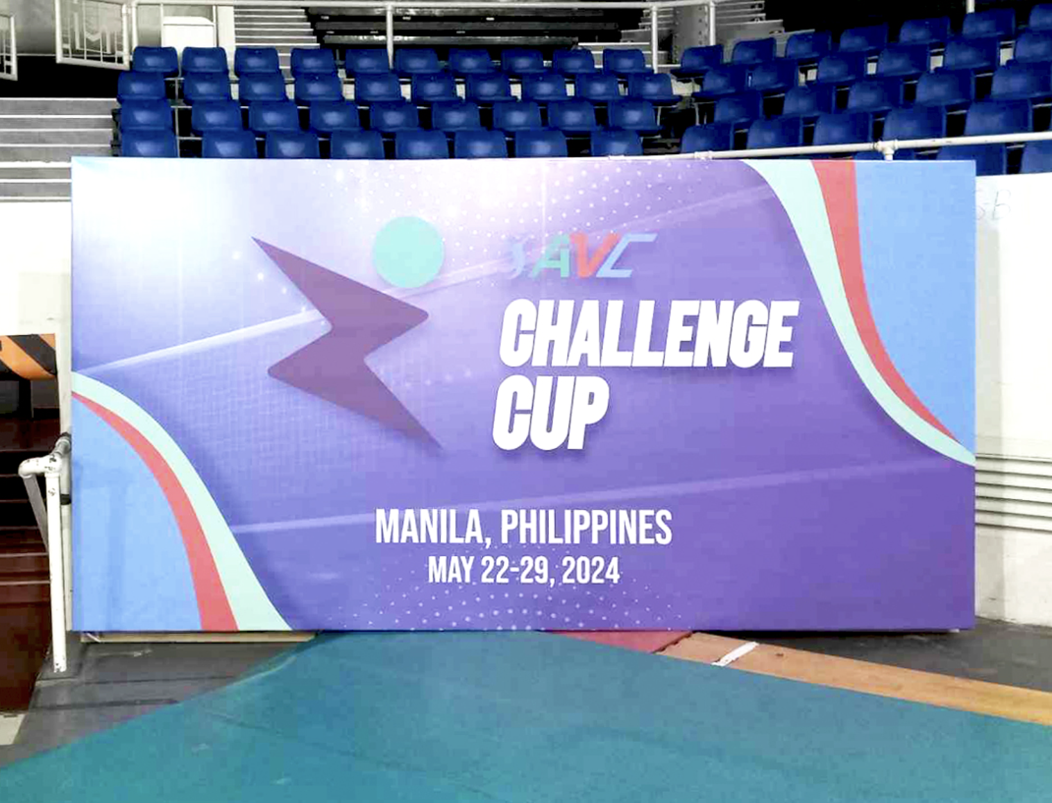 Sign for the 'VHL Challenge Cup' event in Manila, Philippines, held from May 22 to 29, 2024, with a purple and blue background and a lightning bolt graphic.