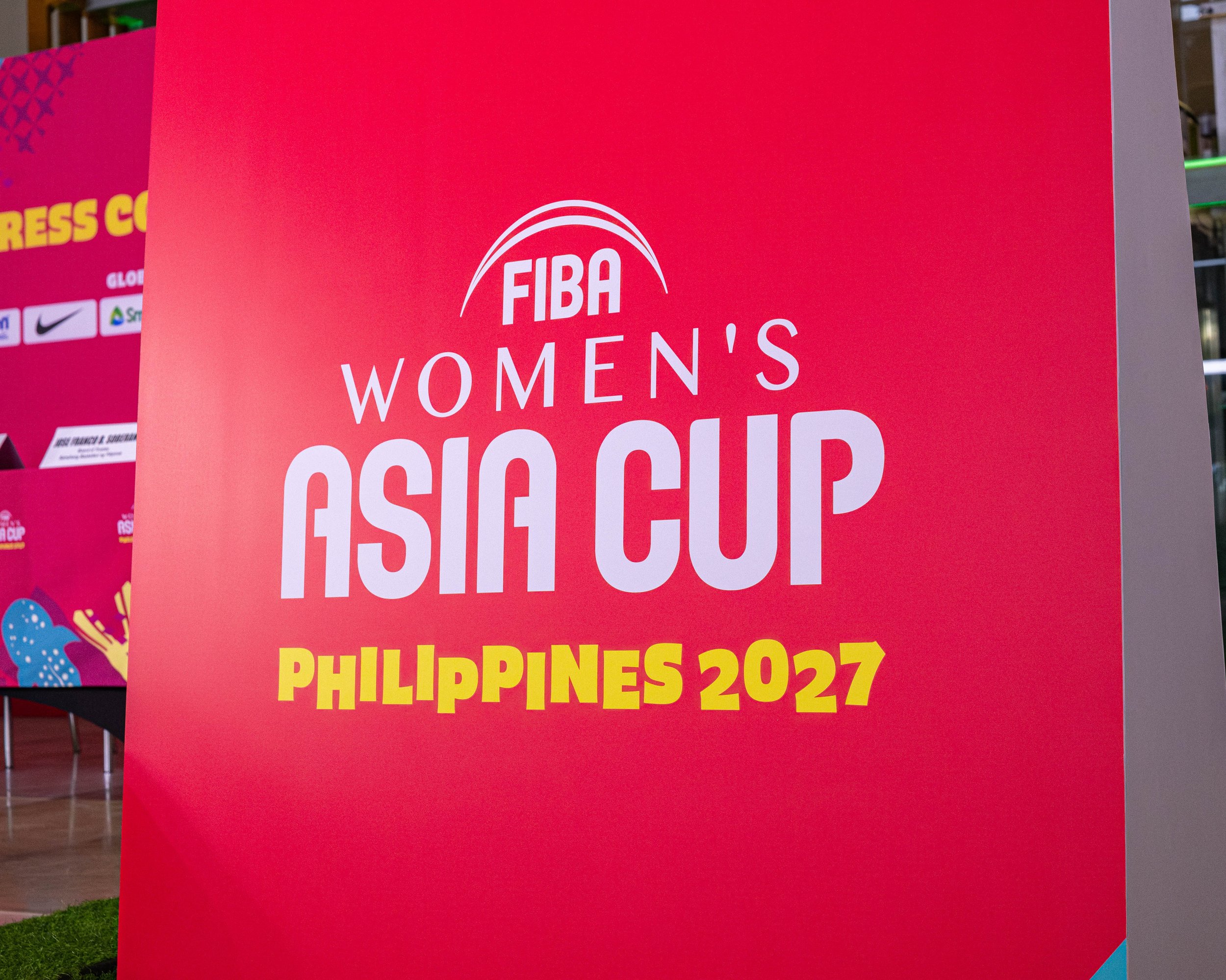 Red sign with white text for the FIBA Women's World Cup in the Philippines 2027.