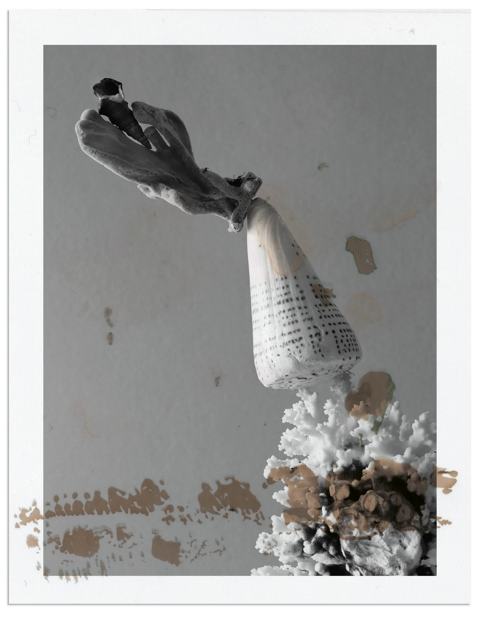 A person holding a lit firework rocket in their hand with smoke and scattered debris on the ground.