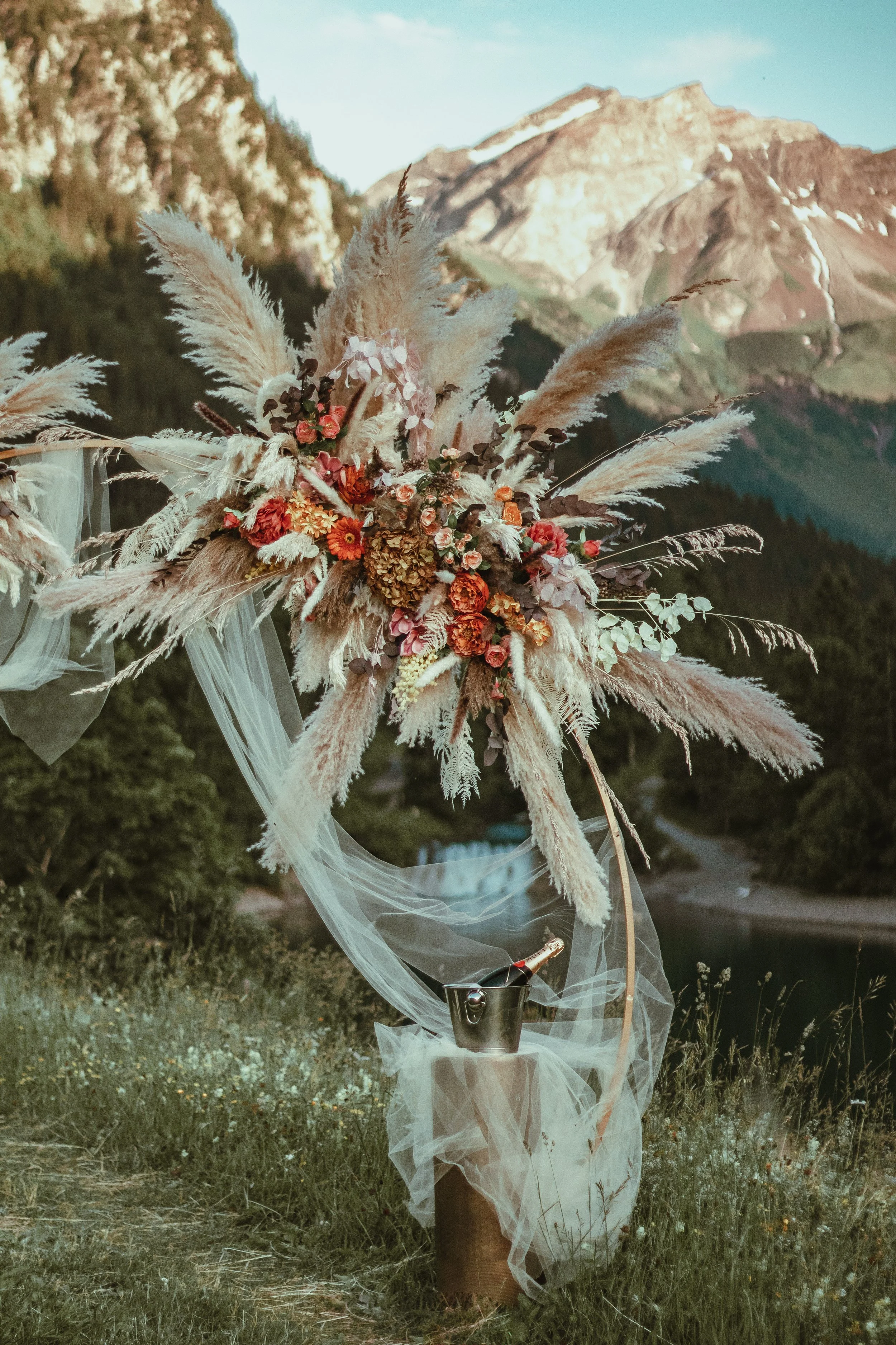 Golden hour proposal photography with a flower arrangement on an arch as a romantic backdrop in the Swiss Alps