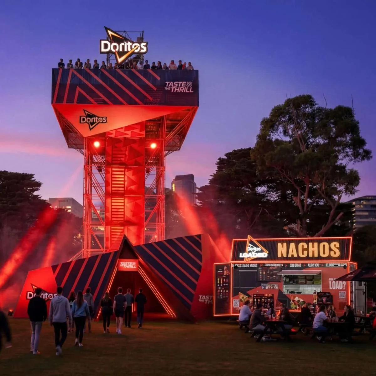 Doritos-branded scaffold with mesh banner outdoor tower and nachos food truck wrap, signage and branding. Doritos tower activation at F1.