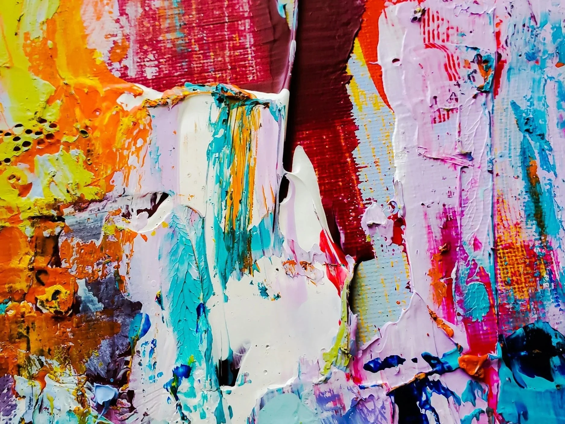 Close-up of thick, colorful abstract paint splotches and textures on canvas in pink, orange, blue, purple, and white hues.