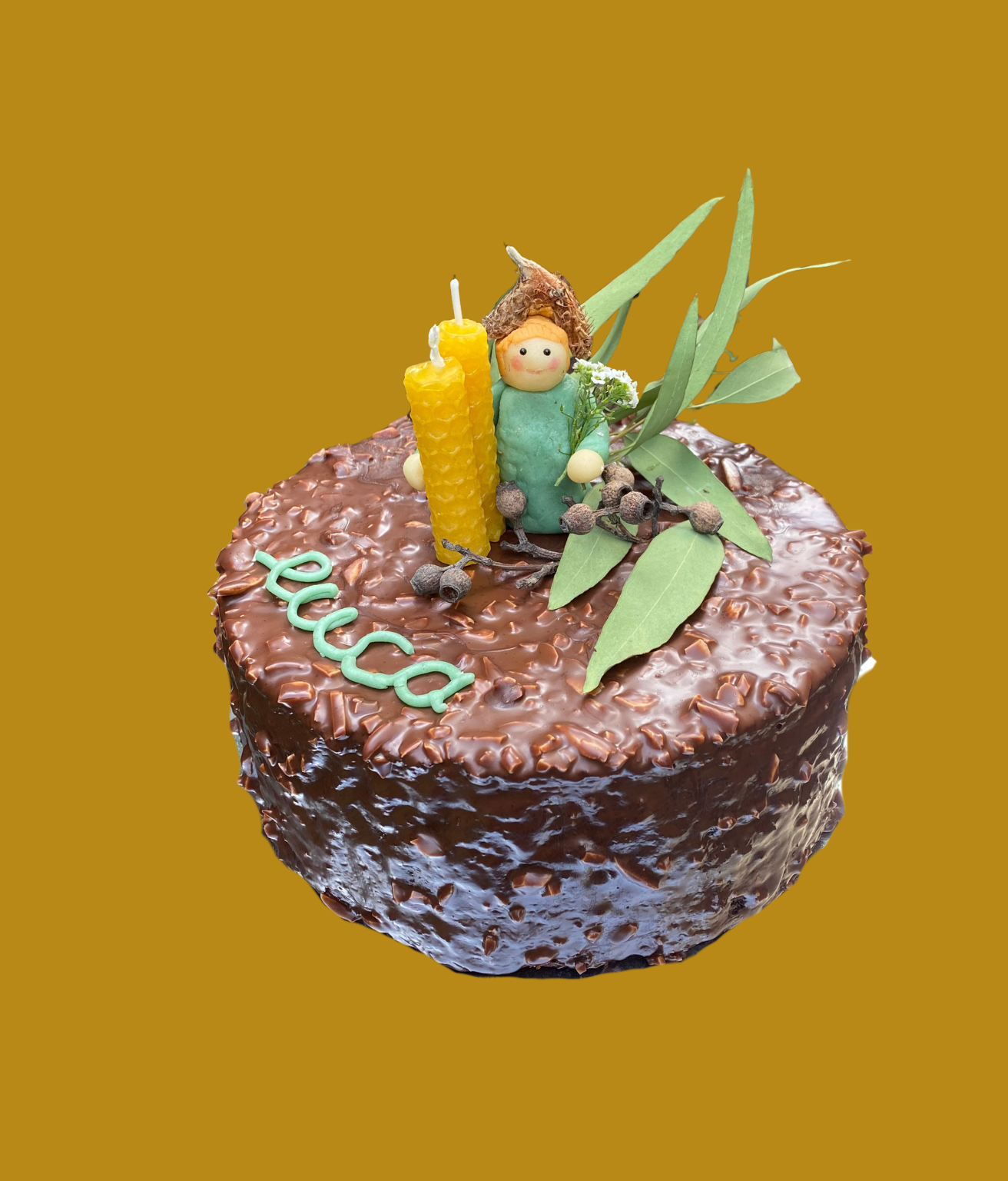 Marble cake with chocolate ganache and a hazelnut coating. Homemade marzipan figurine