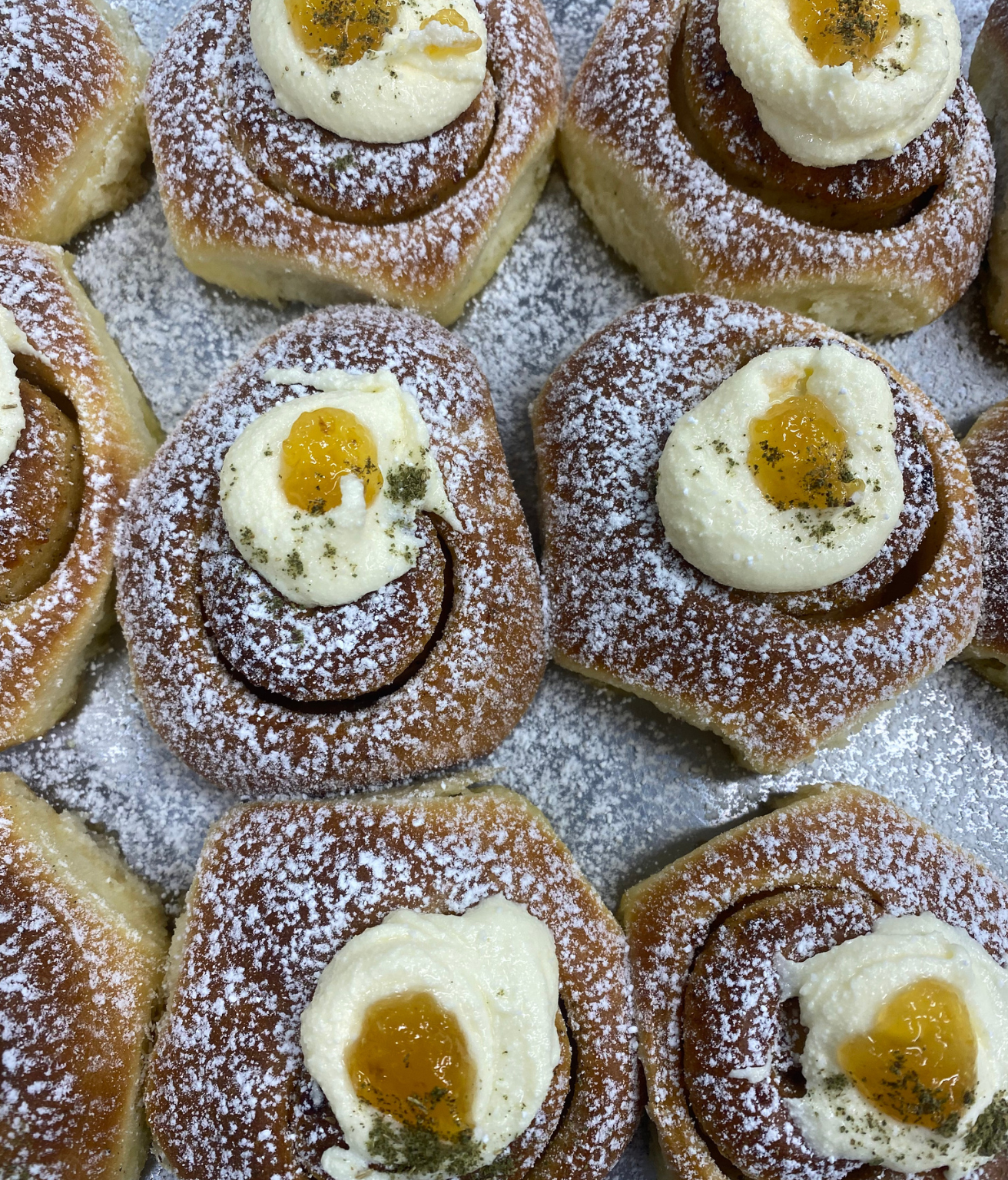 Mini lemon myrtle scrolls with baked cheesecake icing