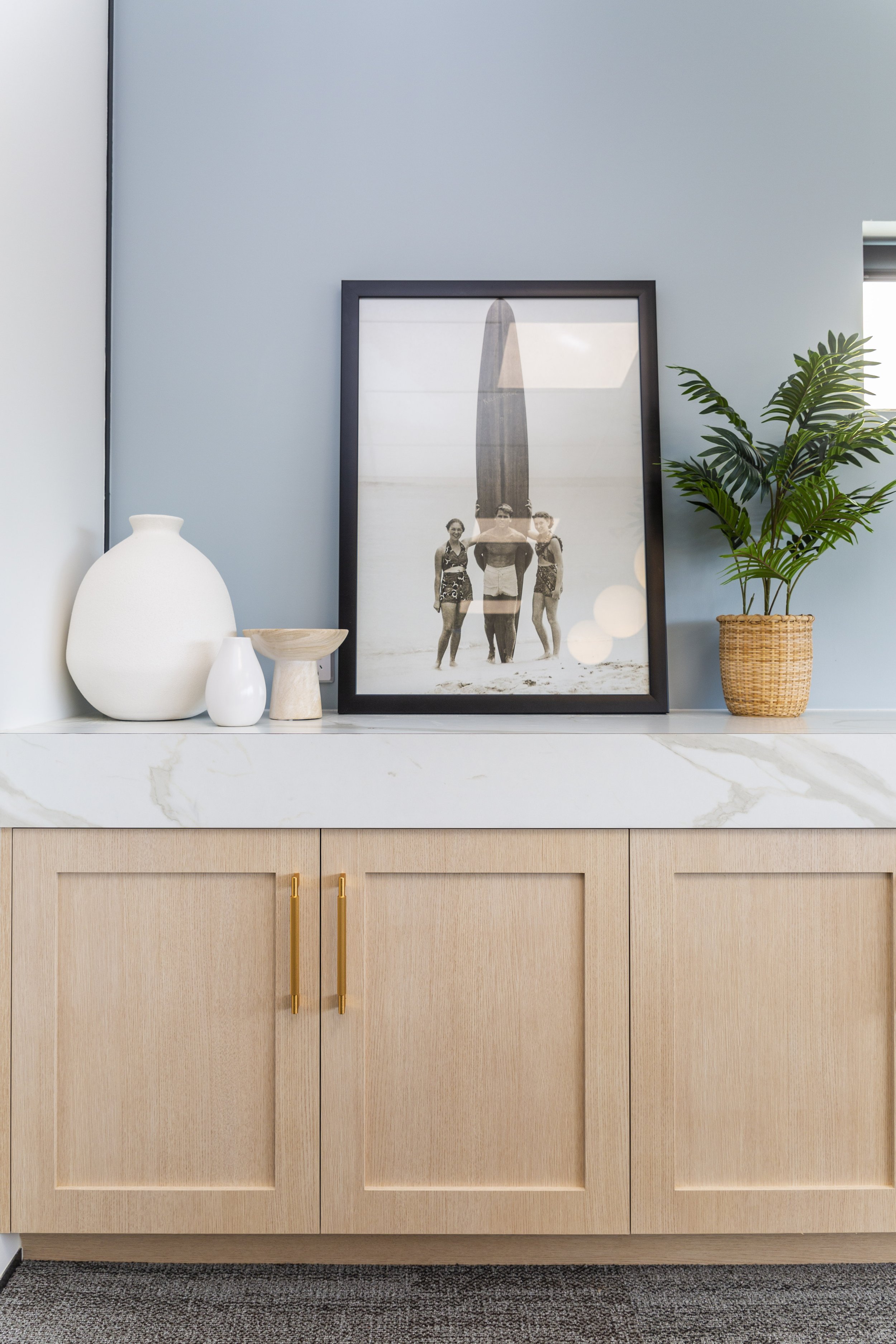Coastal styled office credenza with pale blue feature wall and marble benchtop, Whangaparaoa commercial interior