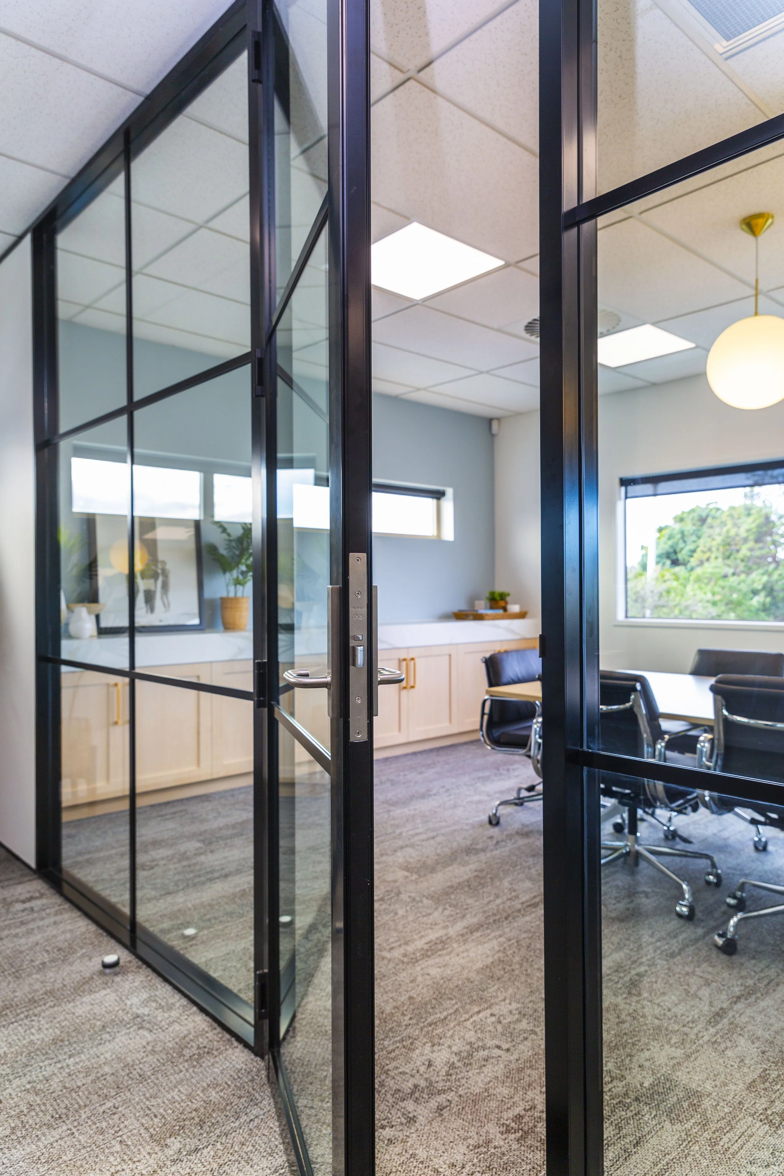Black steel and glass internal office partition, Barfoot Thompson Whangaparaoa commercial fitout