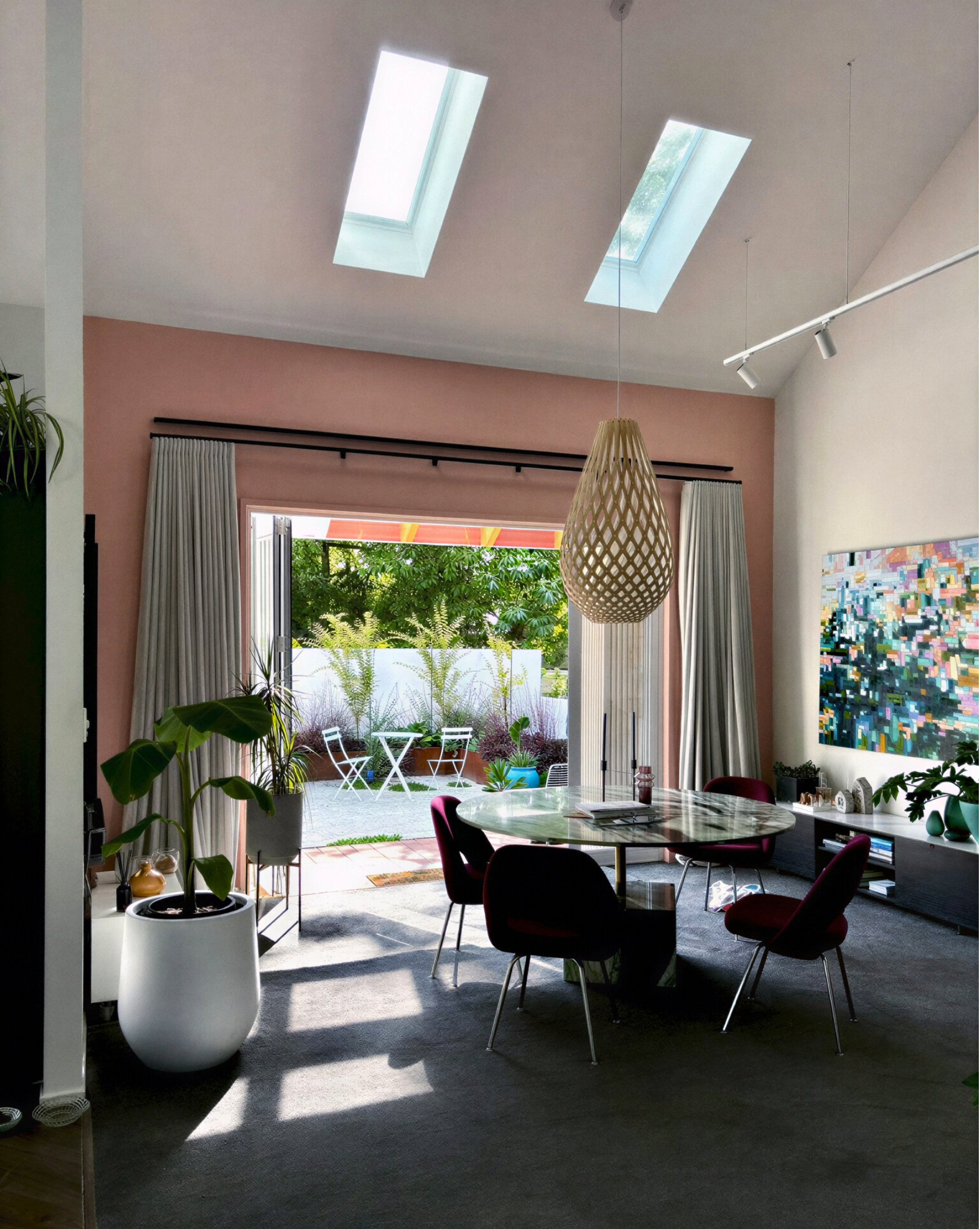 Blush dining room with David Trubridge pendant, marble table and burgundy chairs, Cambridge NZ