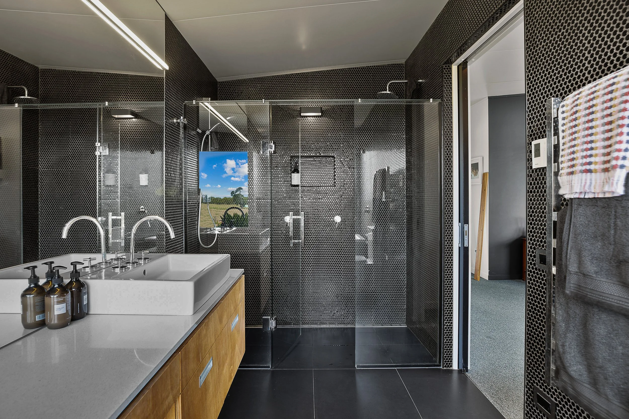 Black penny tile ensuite with double shower and plywood vanity, Big Sky Farmhouse, Kaihere NZ