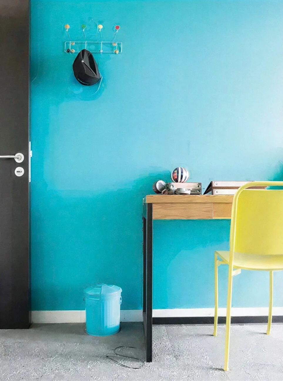 Aqua feature wall with sunshine yellow chair. Big Sky House, Kaihere