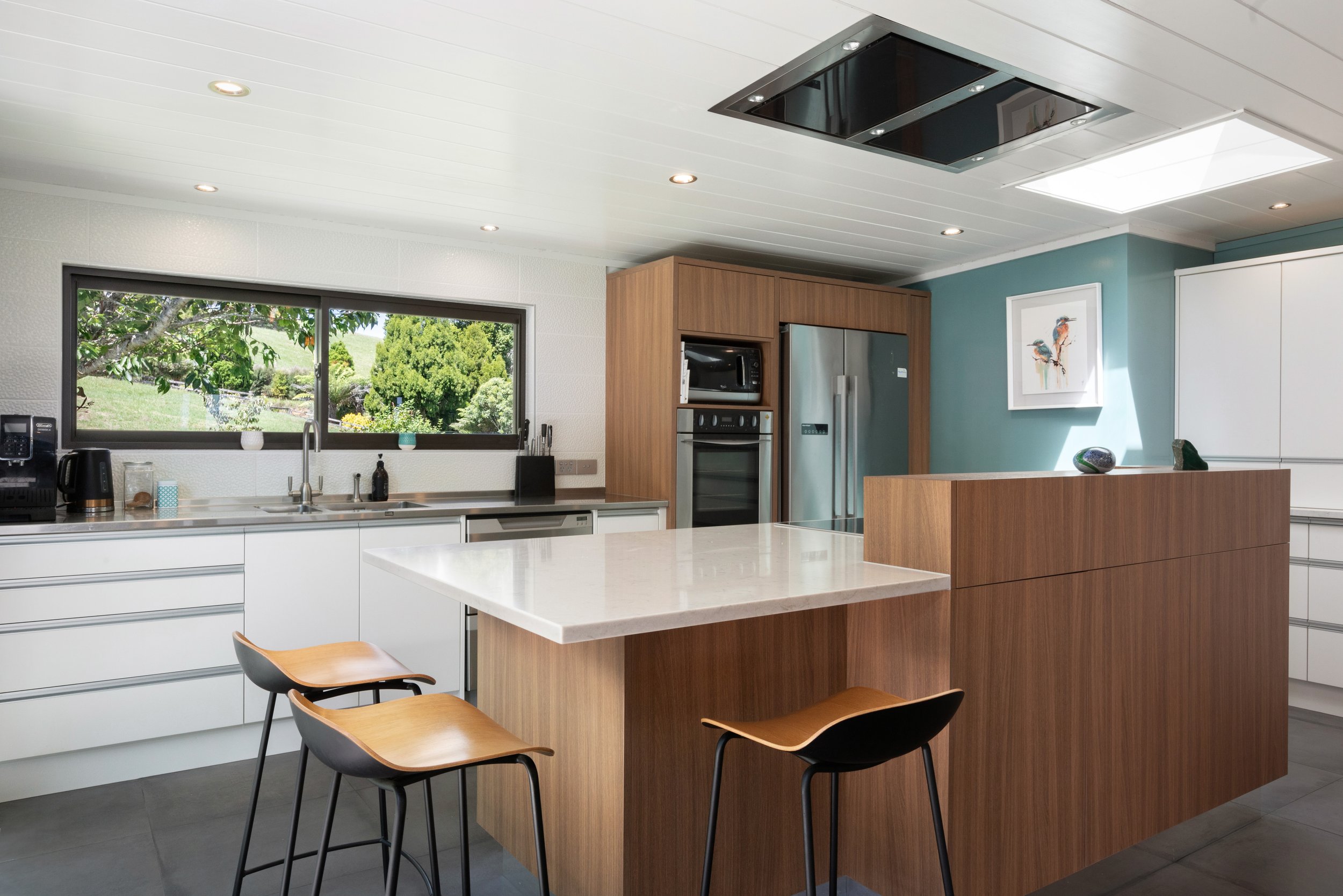 Contemporary kitchen with Melteca Oiled Legno island, white quartz benchtop and teal feature wall, Maratoto Waikato