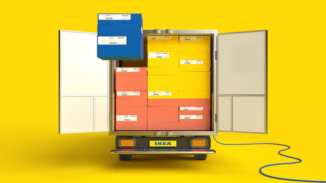 Back of an IKEA delivery truck with open doors revealing multiple stacked boxes in yellow, red, and blue, with labels, against a bright yellow background.
