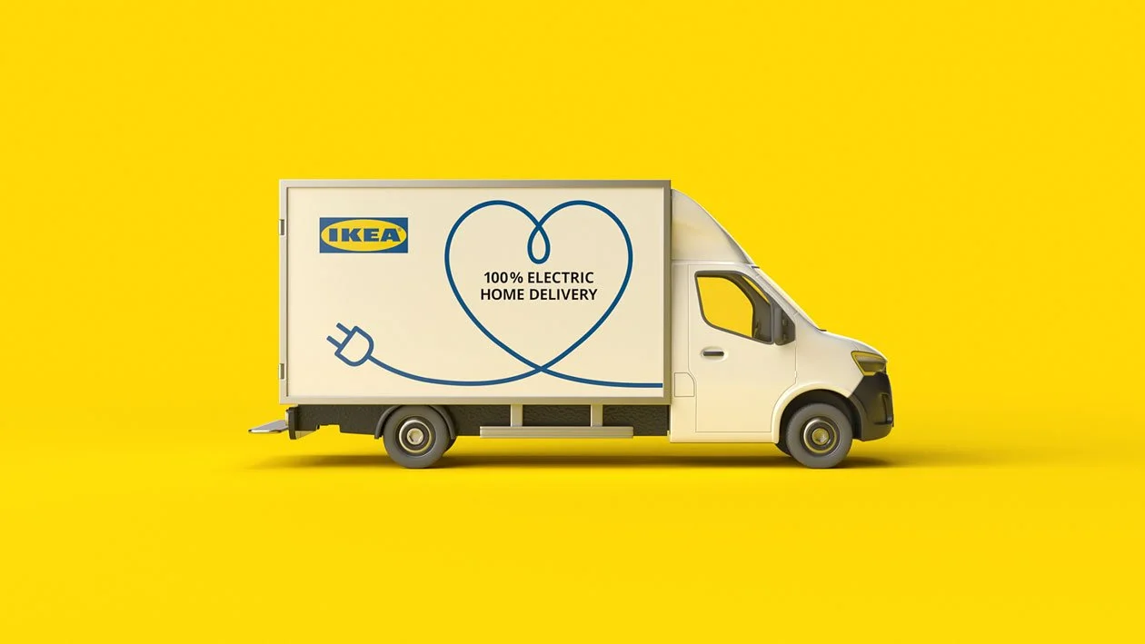 IKEA electric delivery truck with a heart-shaped cord and plug design on a yellow background.
