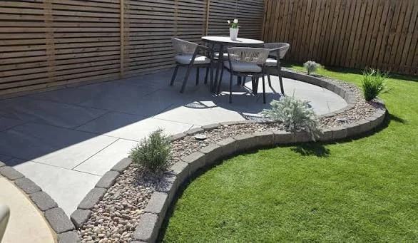 Porcelain patio with curved landscaped borders