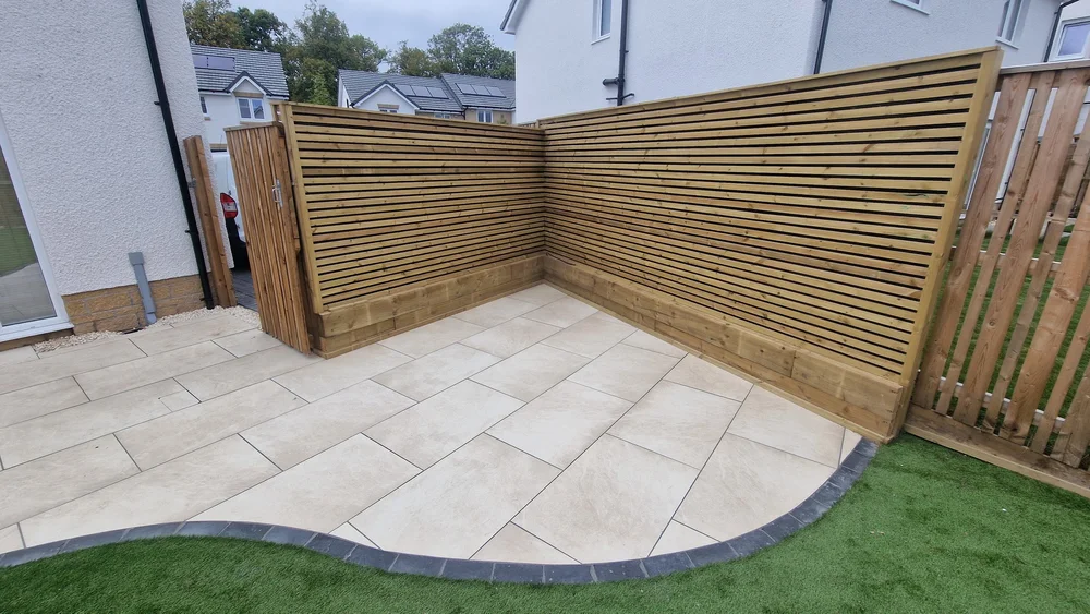 Contemporary timber garden fencing surrounding a landscaped patio