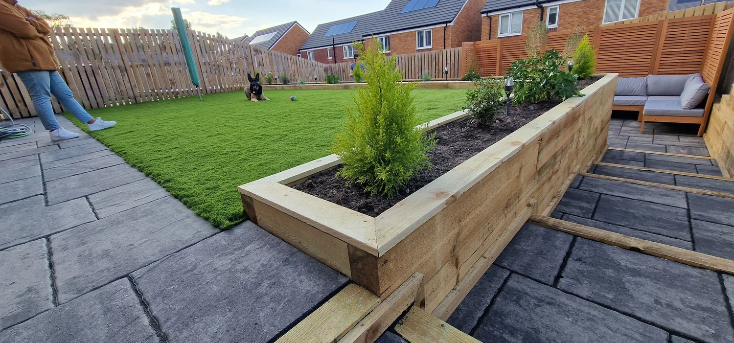 Concrete paved seating area within a landscaped garden by Team Bespoke