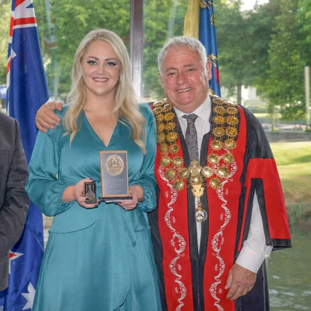 Ashleigh Cottier receiving the Christchurch City Council Civic Award for services to Families from Mayor Phil Mauger in ceremonial robes, 2025