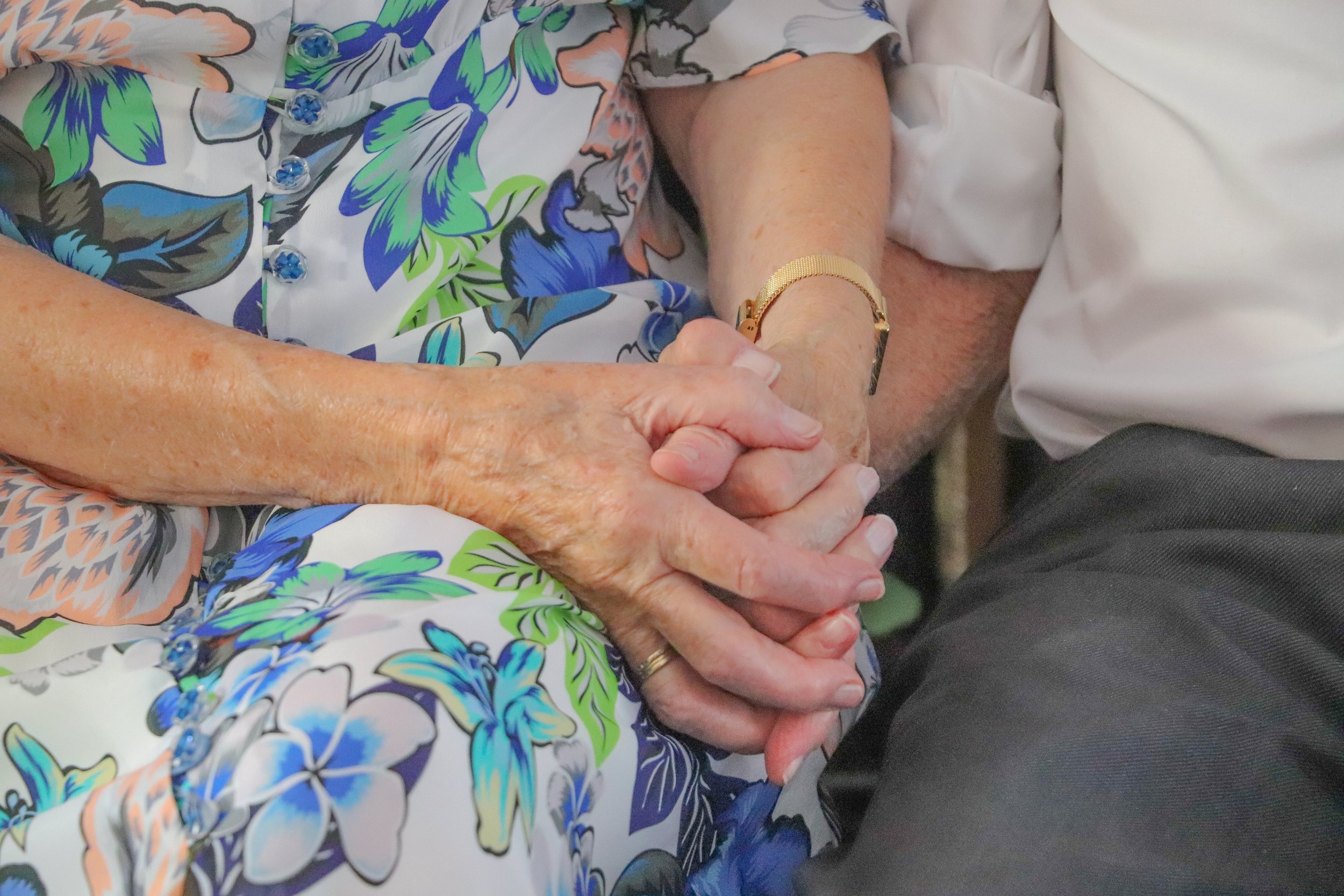 Close-up of an elderly couple holding hands, symbolising love, comfort and connection