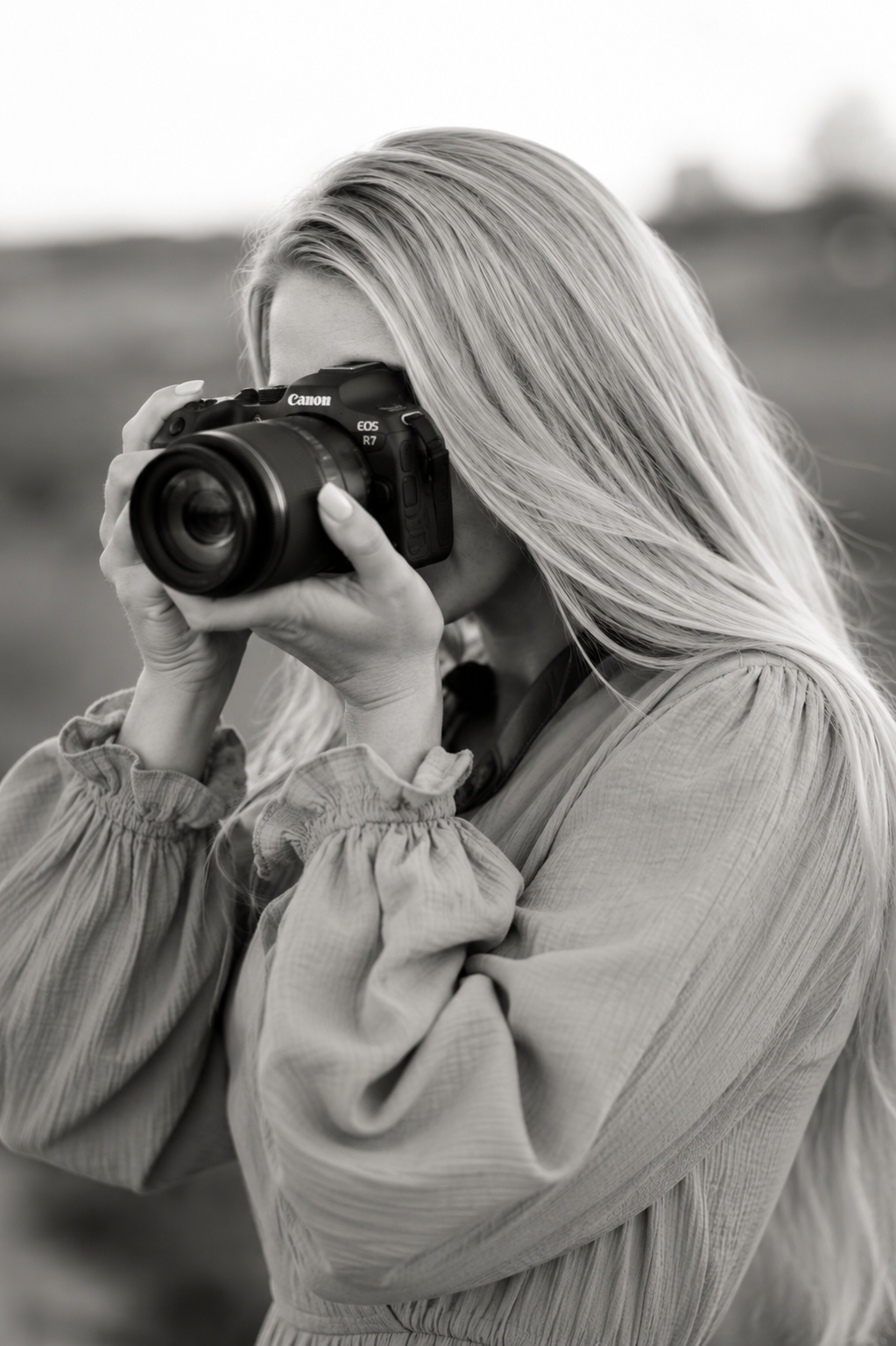 Ashleigh Cottier, Christchurch photographer and founder of Clementine Creative Studio, shooting with a Canon EOS R7 camera — black and white portrait